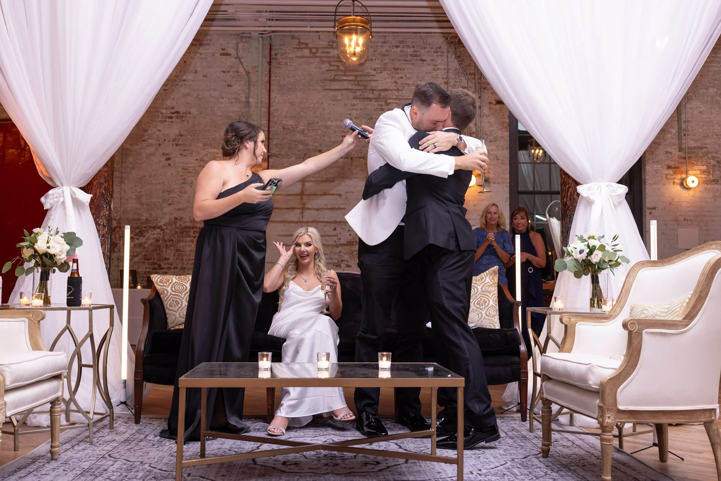 candid of groom hugging best man after toast