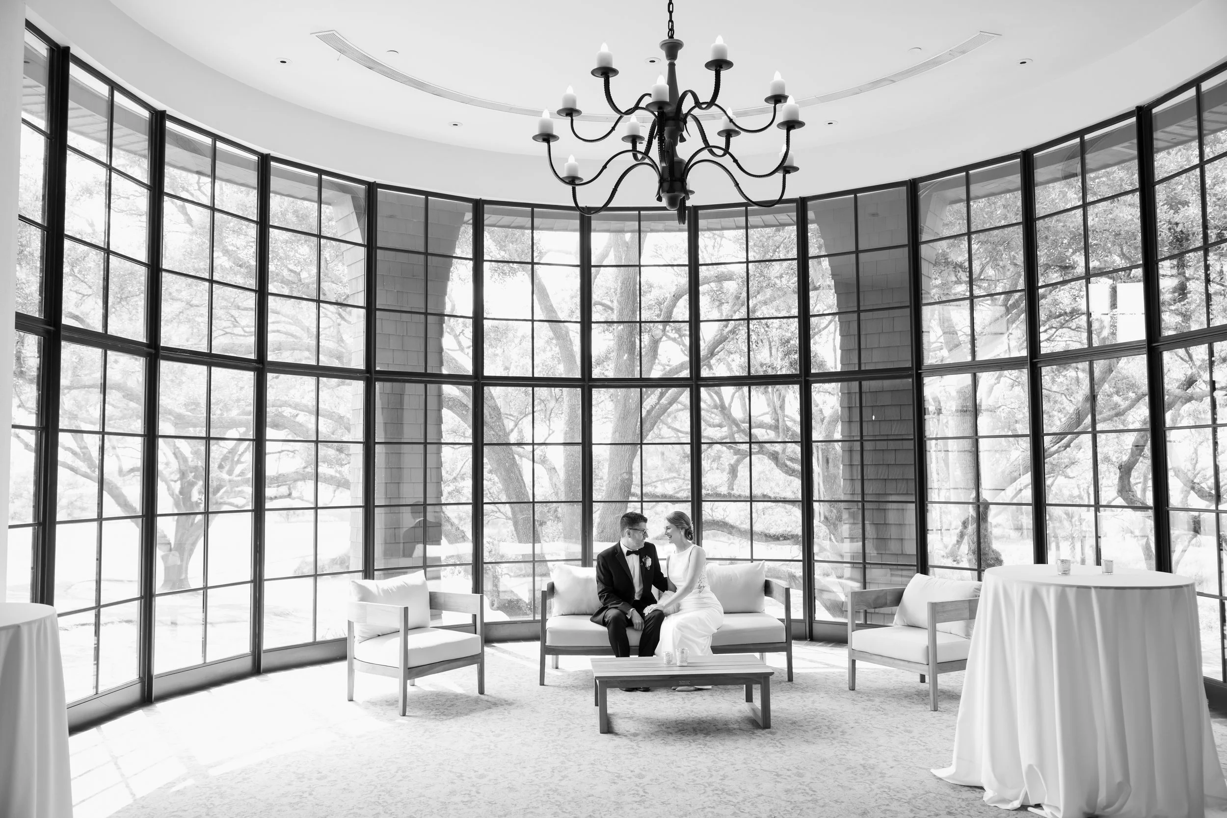 River Course wedding couple sitting in the bank of windows