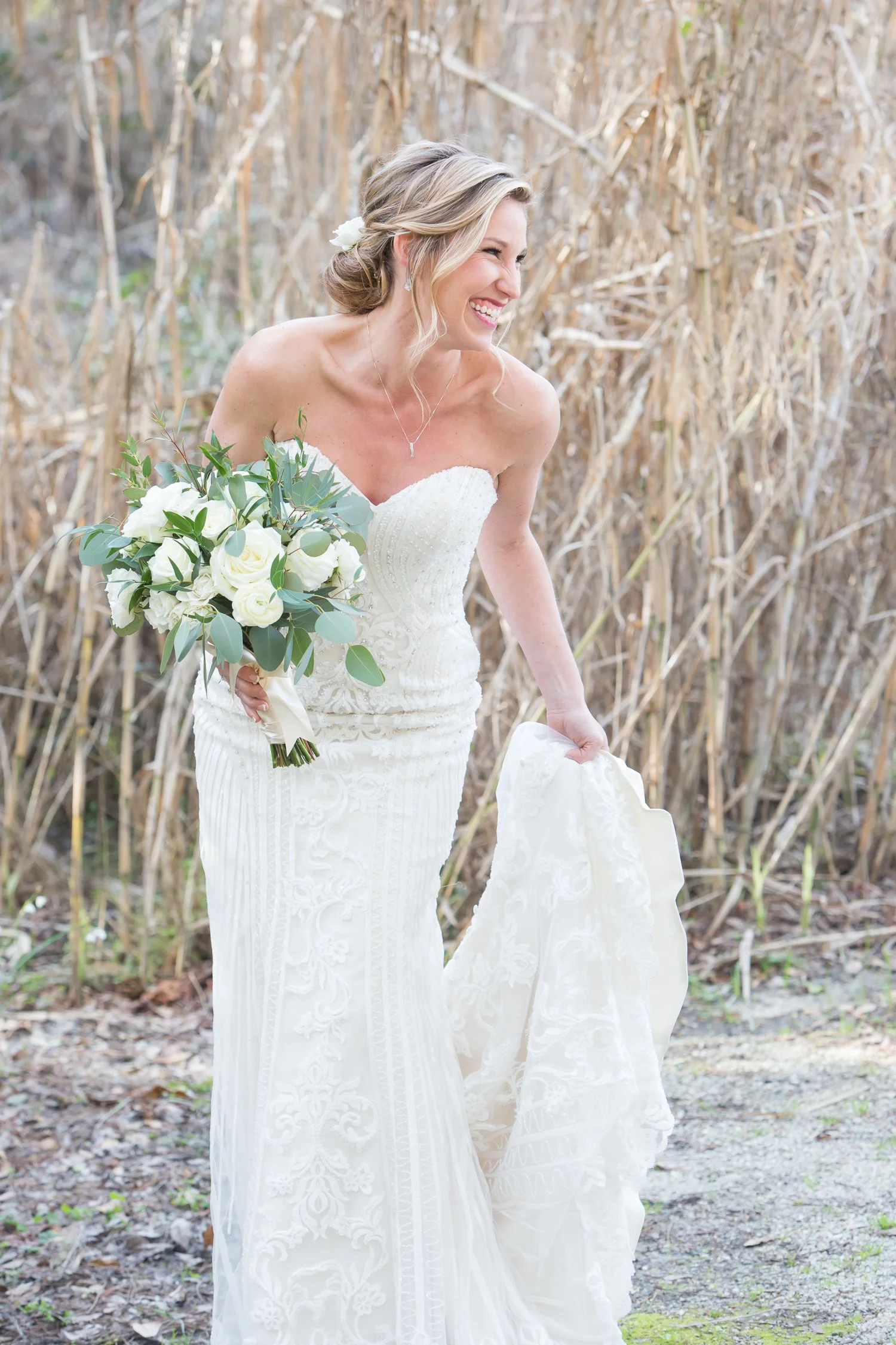 candid of bride laughing with southern blond grasses in background