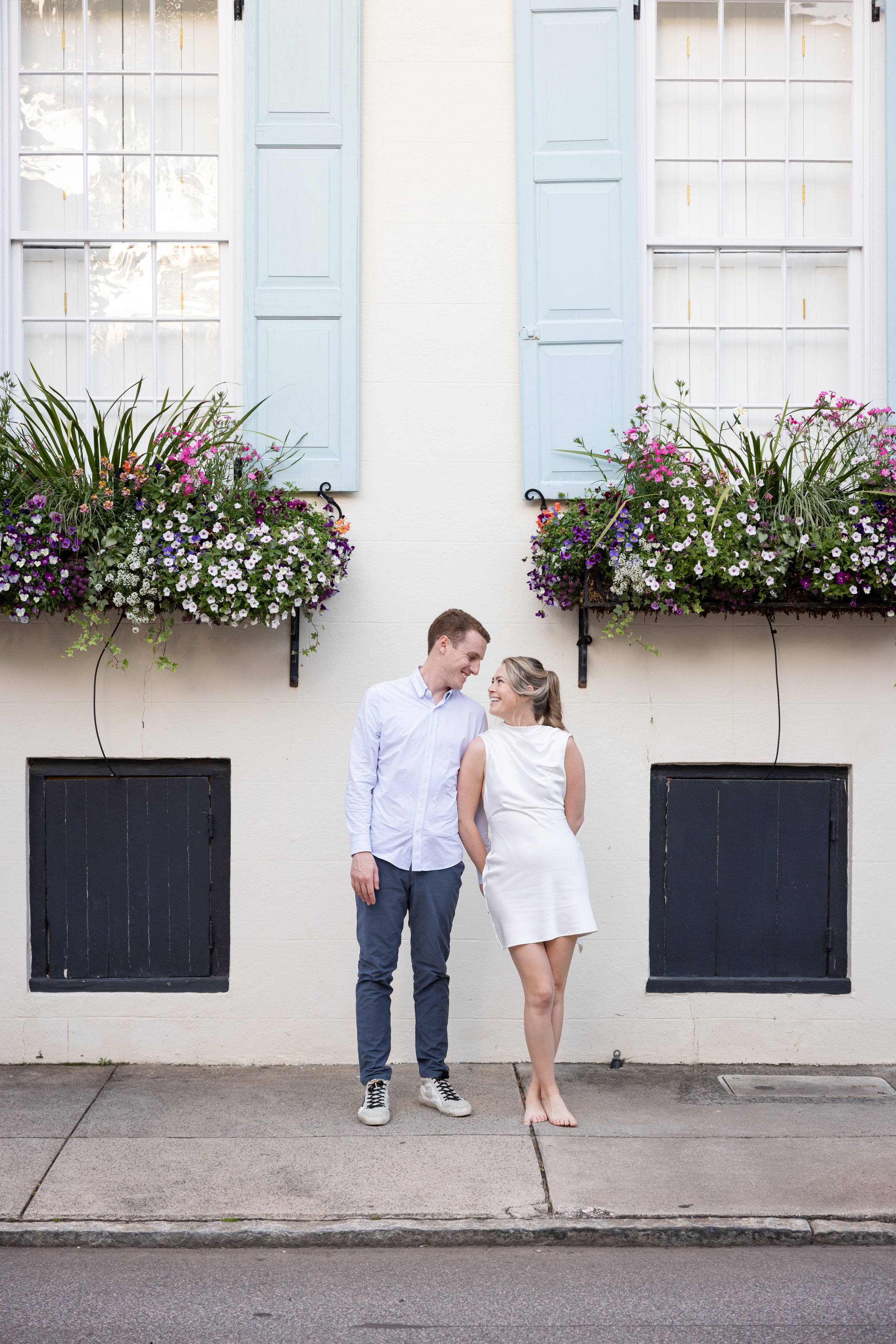engagement photography of couple in flowerboxes charleston street scene