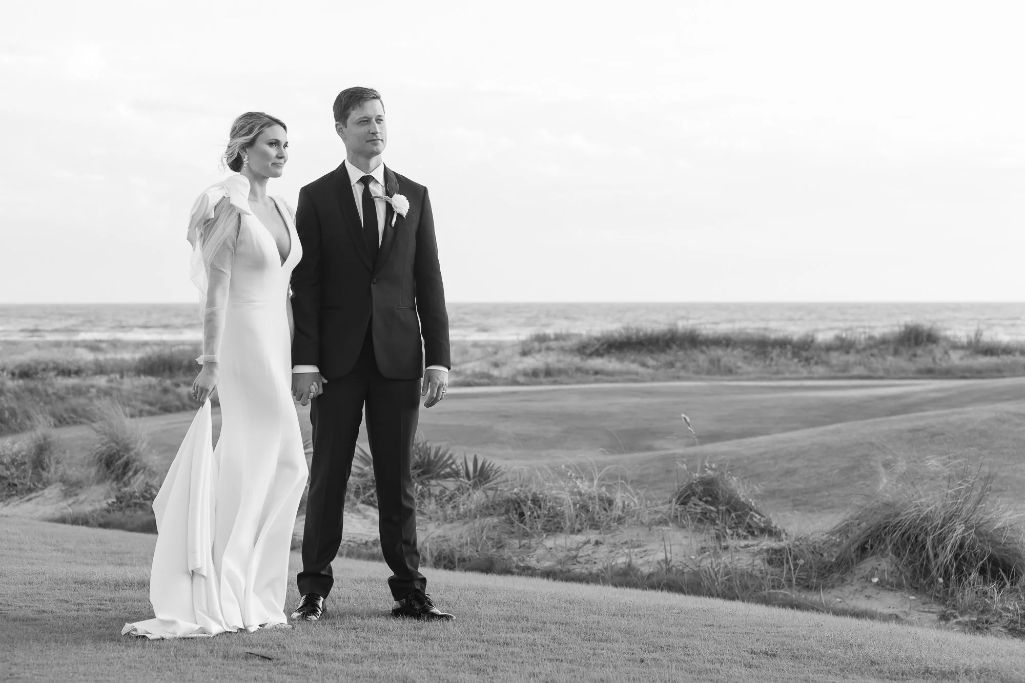 bride and groom at outdoor Kiawah wedding posing for photographers