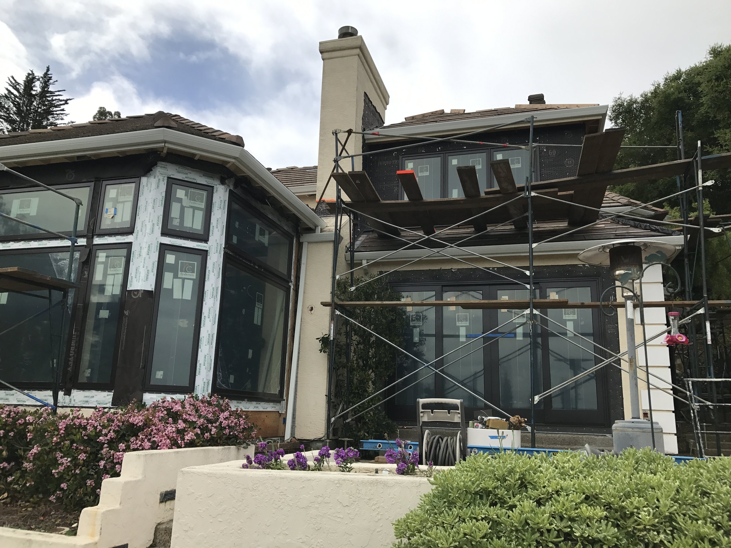 The project is a whole house redo inside, replacing all windows and exterior doors, and a small exercise room addition on the second floor.