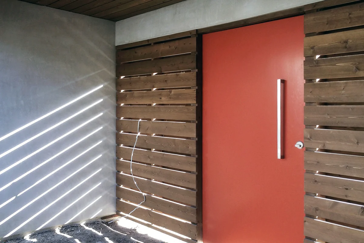 orange entry door at courtyard