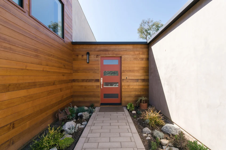 clear cedar + smooth stucco at entry