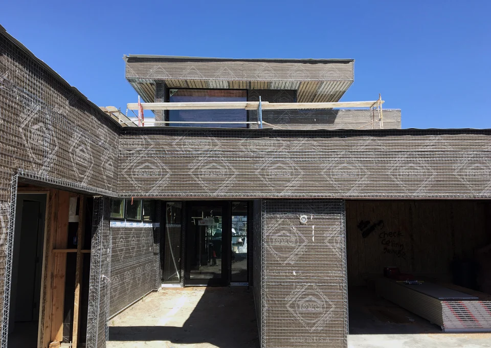 paper + lath at exterior / front entry