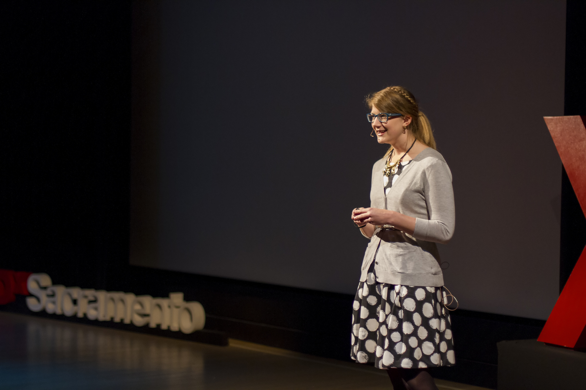 Emily Graslie, Chief Curiosity Correspondent for the Field Museum, speaking on the TEDxSacramento stage.