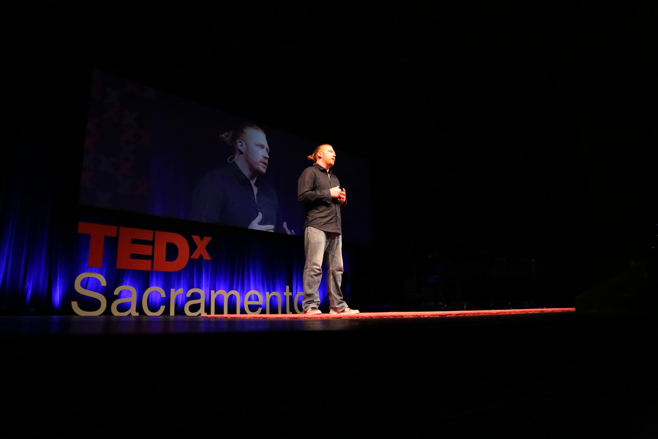 TEDxSacramento speaker Alexander Dervin on the TEDxSacramento stage. Photo: Phil America.