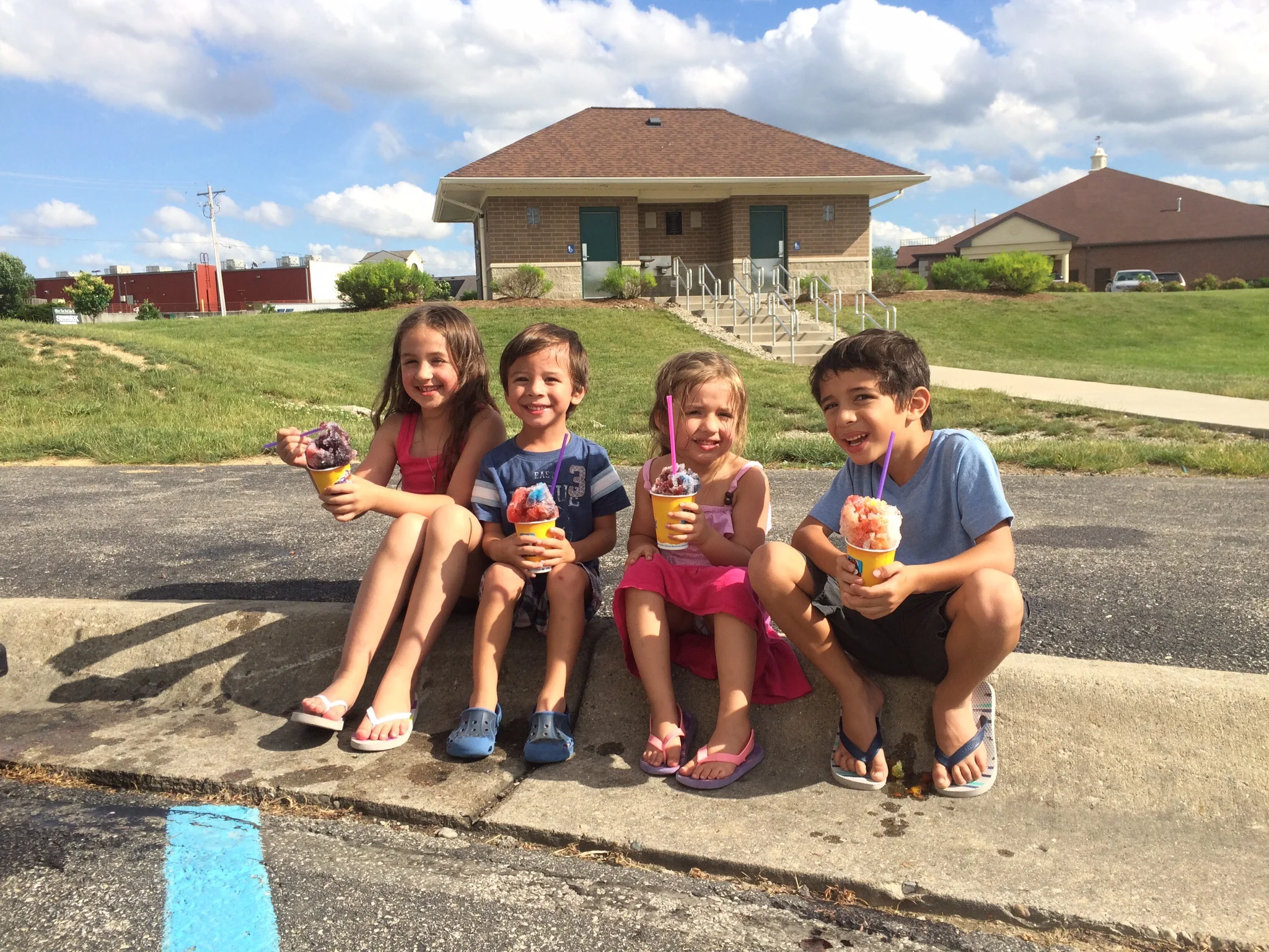 Taylor, Noah, Jordy and Koa eating shaved ice after playing in the park
