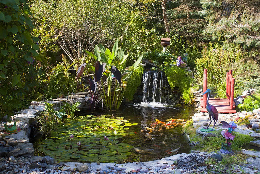 Image of Peaceful pond surrounded by trees and flowers