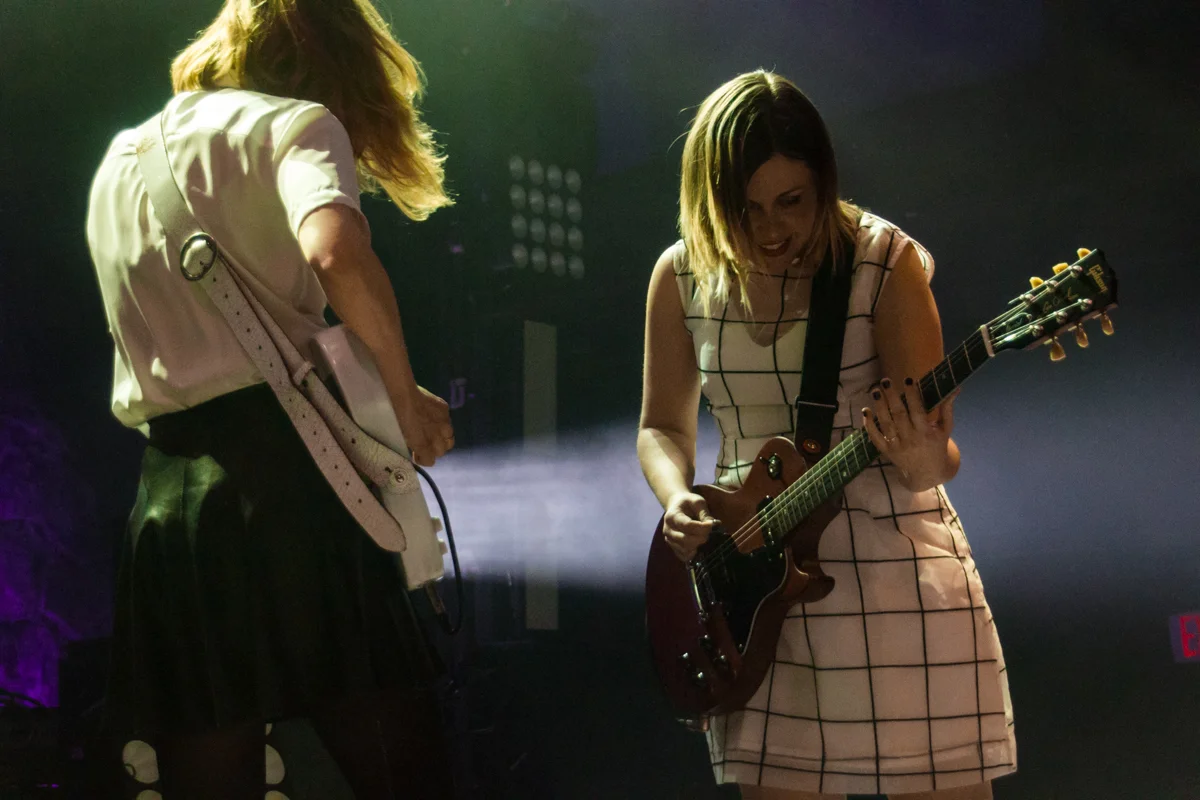 Carrie Brownstein and Corin Tucker of Sleater Kinney making with the rock moves at the 9:30 Club (photo by Kevin Hill)