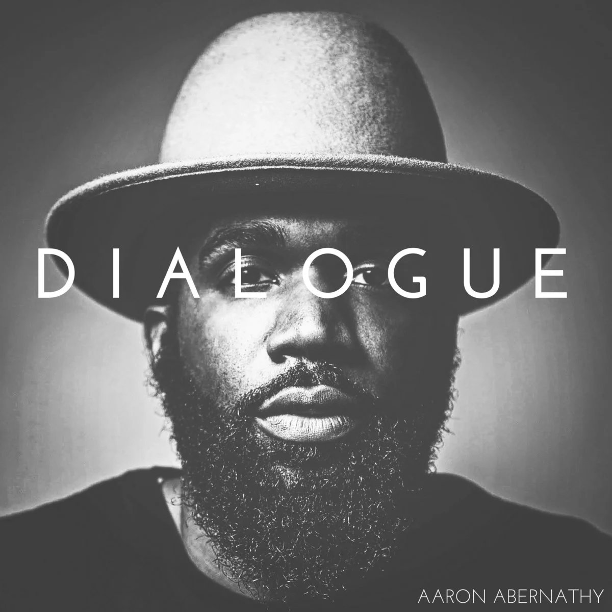Dialogue - Aaron Abernathy "A spiritual heir to Marvin Gaye's What's Going On , Dialogue finds Abernathy looking at the world around him, and searching deep inside AND out for answers to the daily horrors that seem to have taken over the zeitgeist. What does it mean to be decent in a world that seemingly only rewards depravity? How can an African American survive in a society that continues to not just perpetrate, but ostensibly celebrates systemic white supremacy? Do even the smallest of human actions matter?" I wrote that in our initial review of this masterpiece, and since then I've had the pleasure to sit down with Abernathy and discuss not just how he came to translate these important themes and questions into such a potent musical message (Listen to Part 1 | Part 2 ), but to see the his work evolve into a true dialogue, not just with his community but the larger world outside it. Faith plays a huge role on Dialogue , and in Abernathy's life, but the key to not just internalizing the album's message, but practicing its gospel of peace is to understand that faith can take many forms. What is most important is that we all at least try to look at our world and the people in it with love, compassion, and faith that even in the darkest times, we CAN do better. 