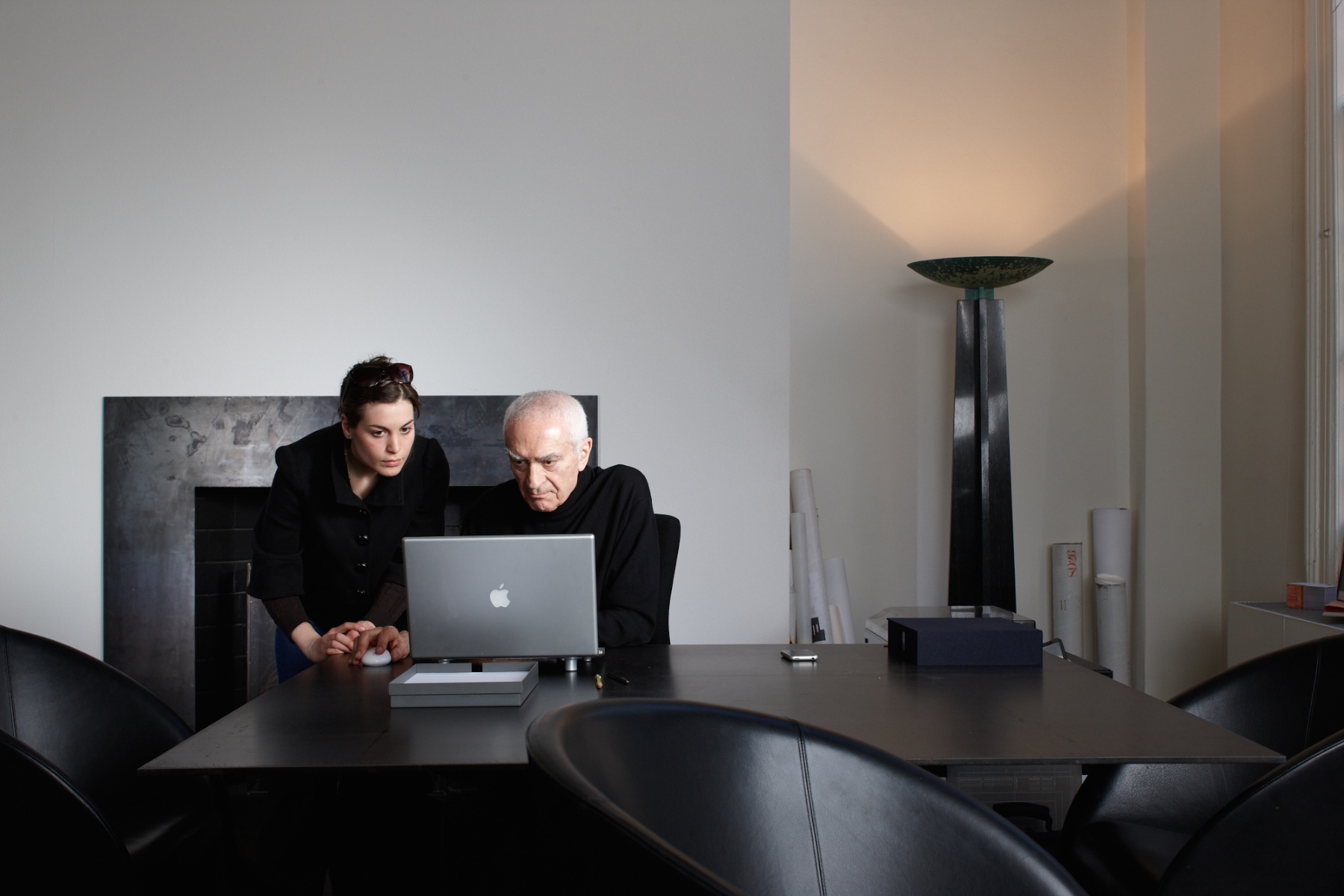 Massimo working with one of his designers at the incredibly uncluttered desk where he did much of his design.