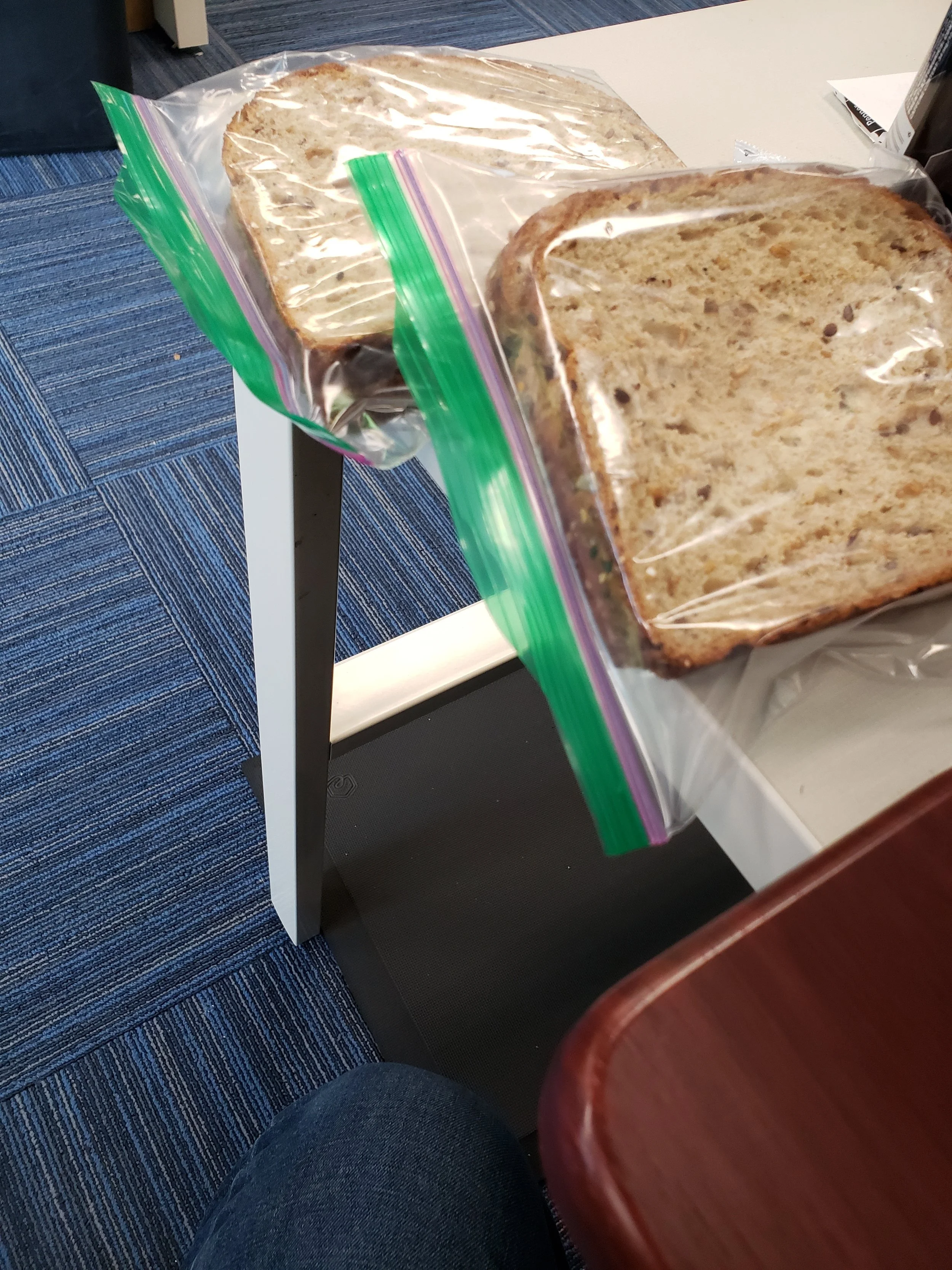Two peanut butter and jelly sandwiches on Dave's Killer bread