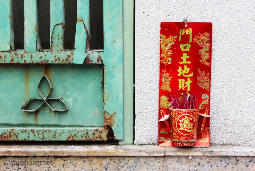 Incense offerings mounted outside an apartment 
