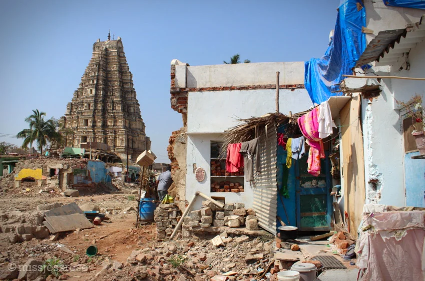 Some people's houses remain intact and they continue to live next to the demolition site