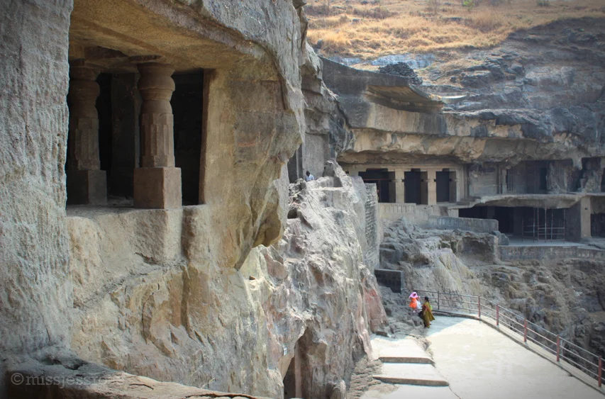 The exterior of Ellora caves, which are carved into a basalt rock cliffside.