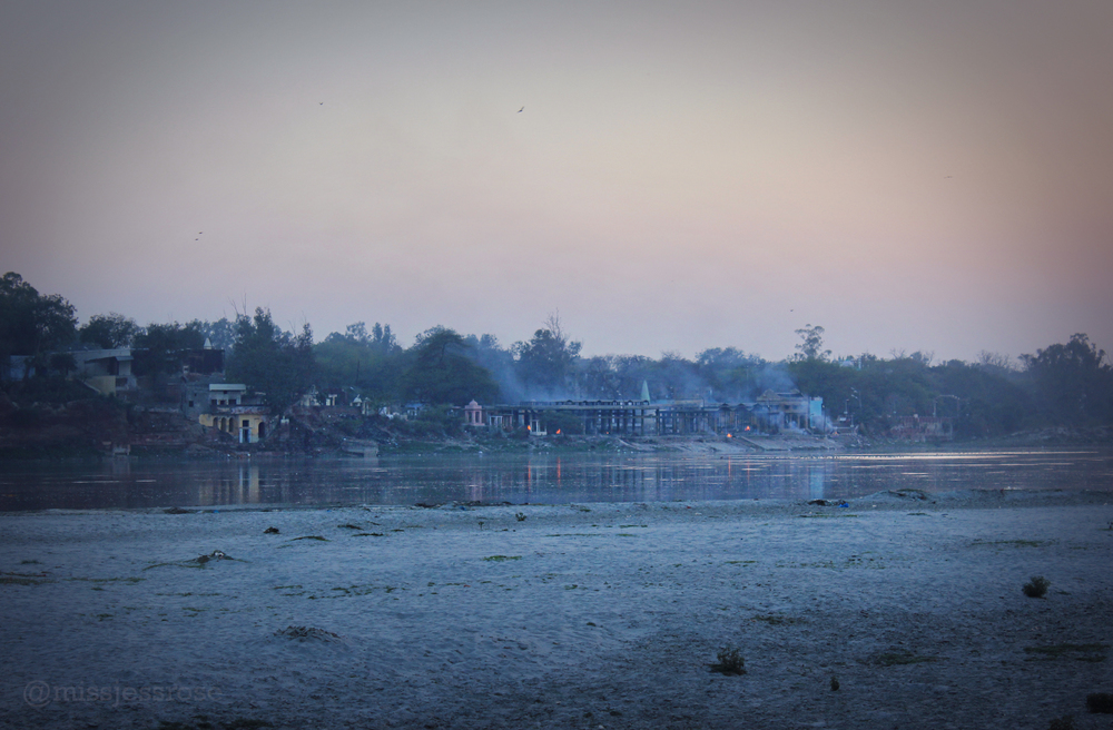Fires burning alongside the Yamuna river near the Taj at dusk