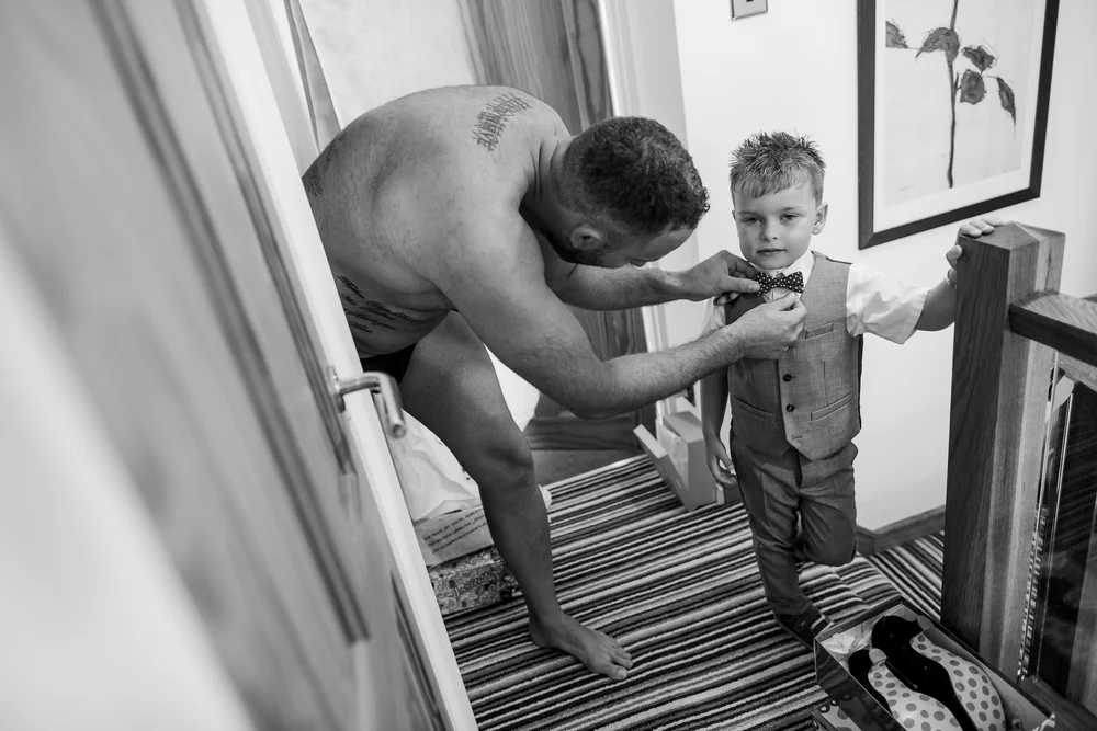 Boy getting dressed - wedding clothes - Yorkshire wedding 