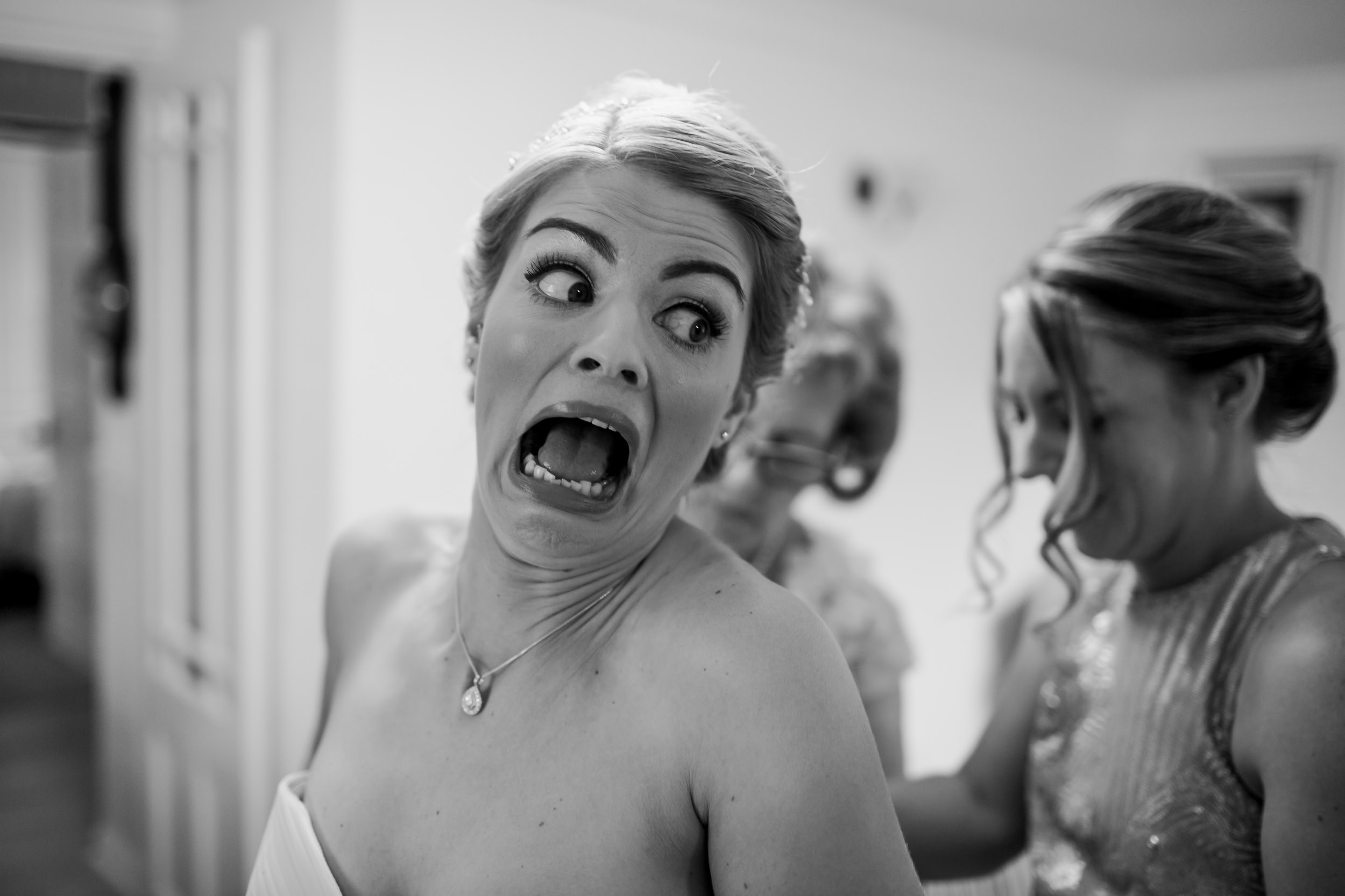 Bride getting dressed - bride pulling a funny face - Yorkshire wedding 