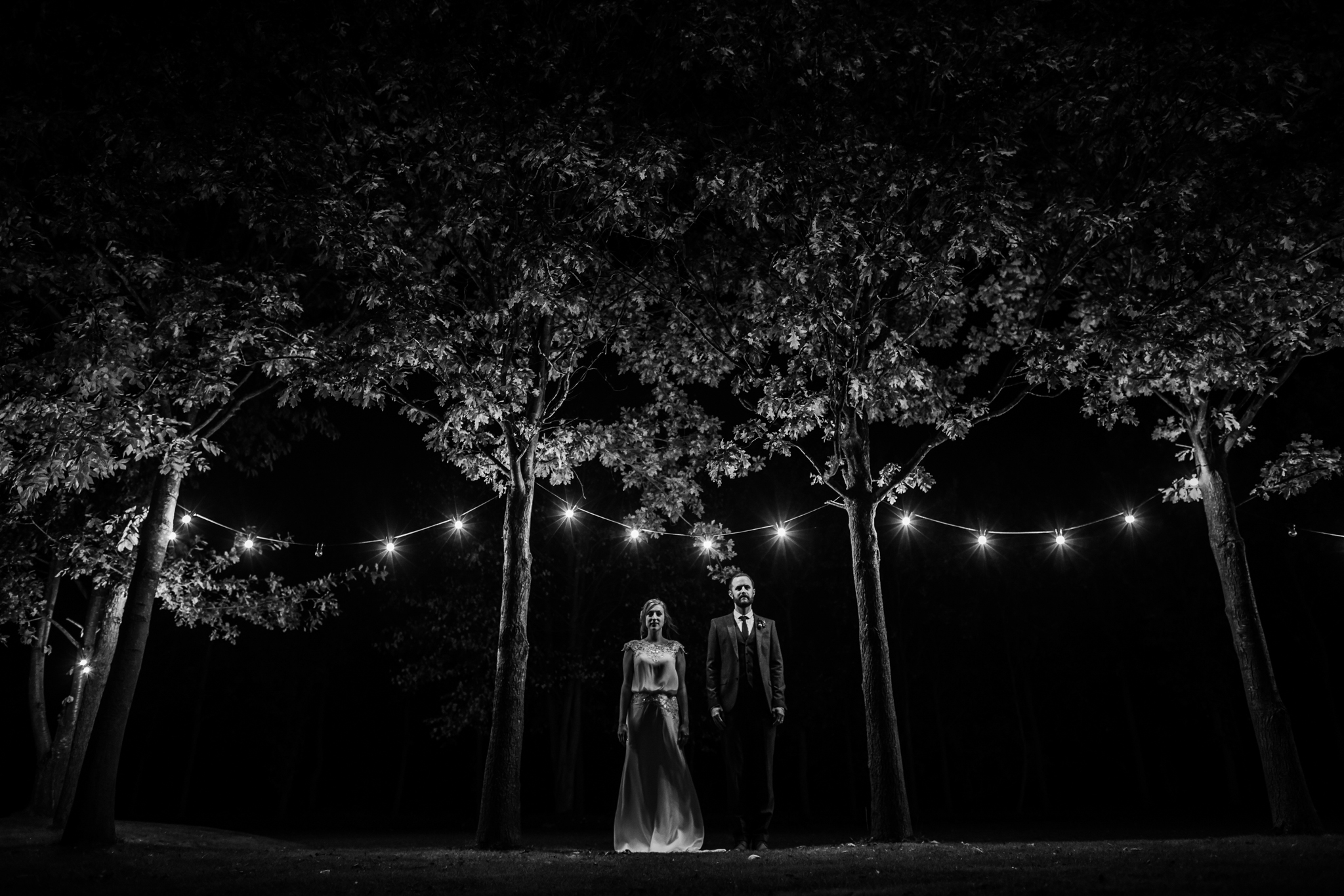 portraits under festoon lights at shustoke barn