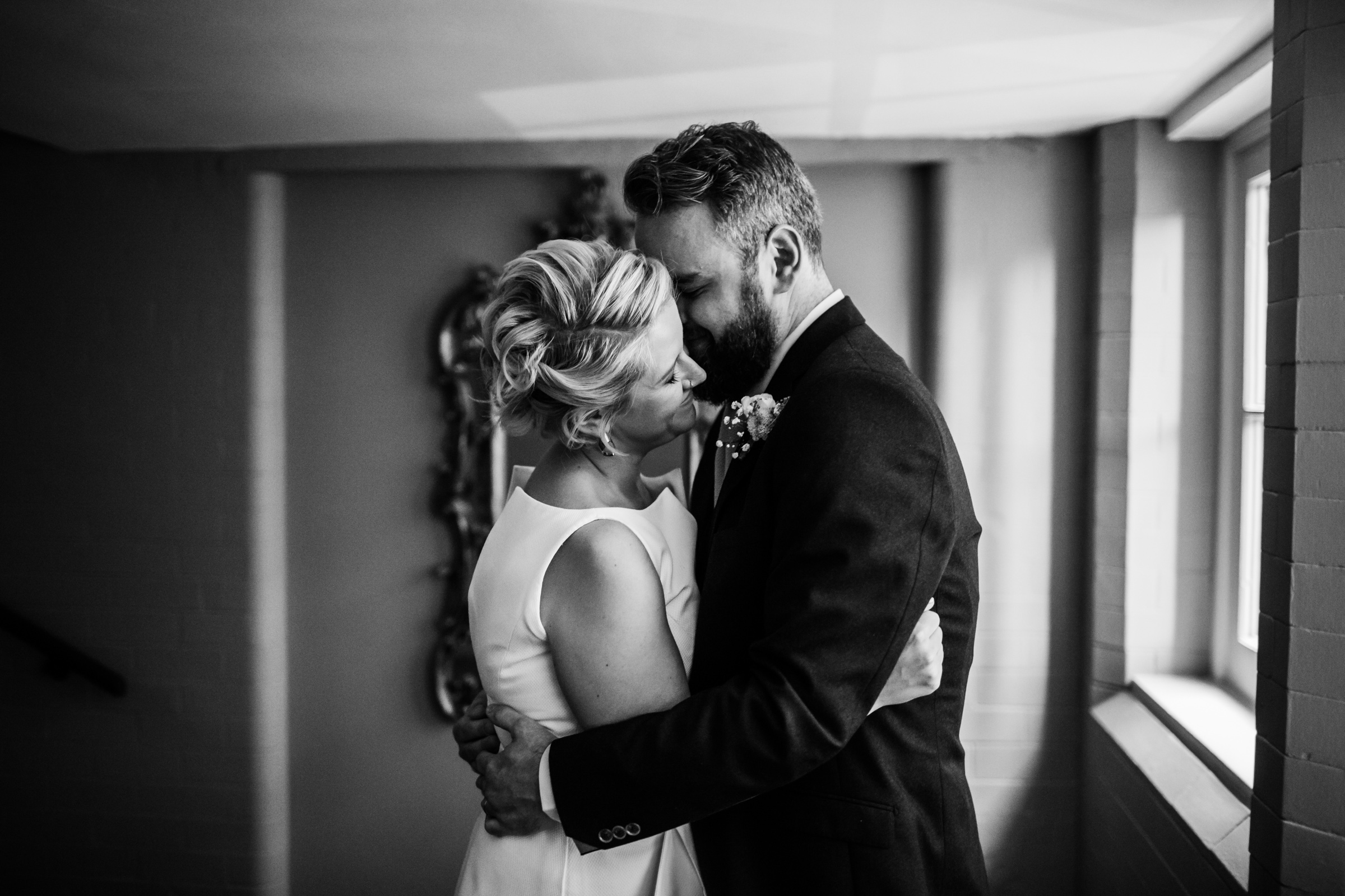 a bride and groom cuddle at great john street hotel manchester