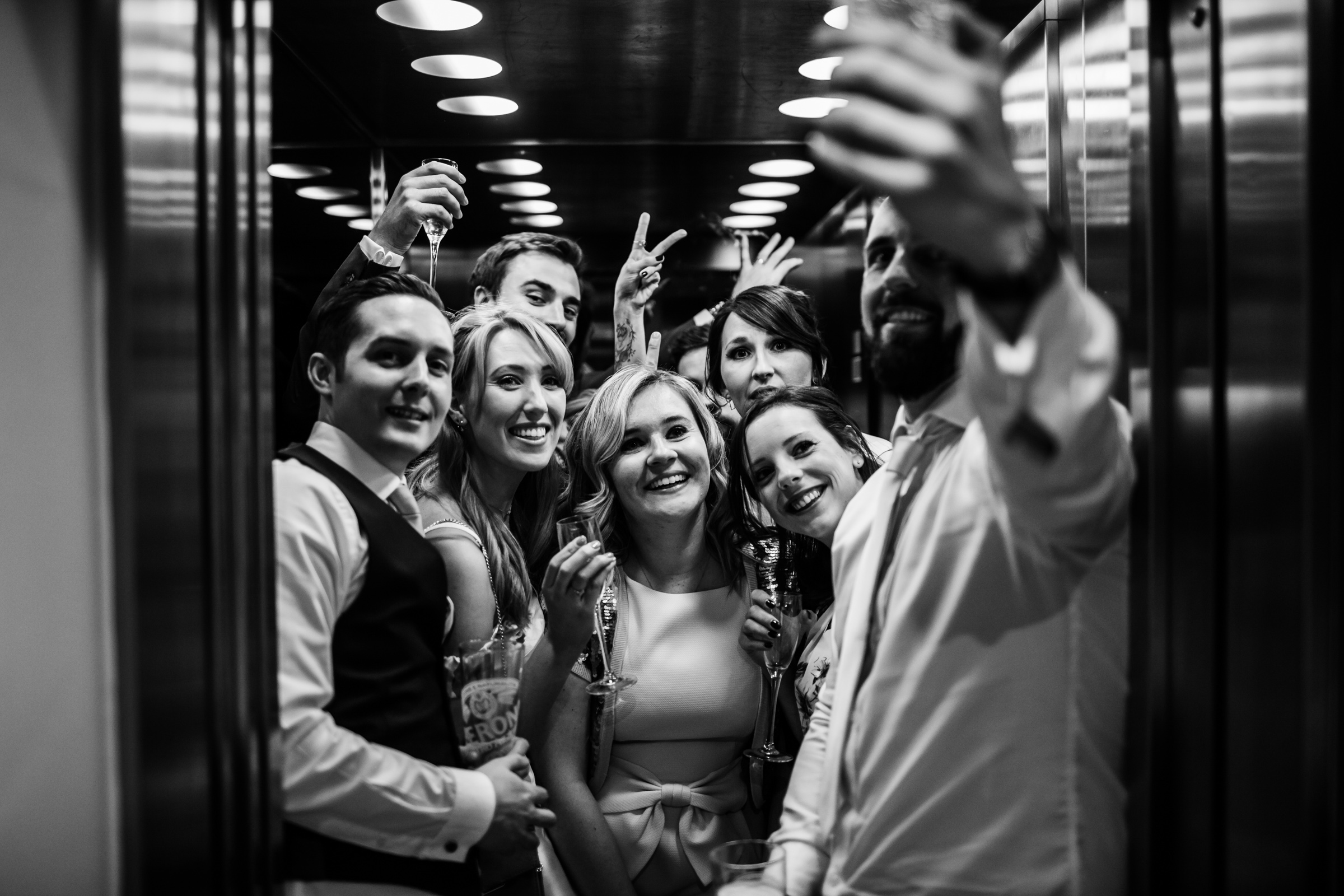 wedding guests in the lift at great john street hotel manchester