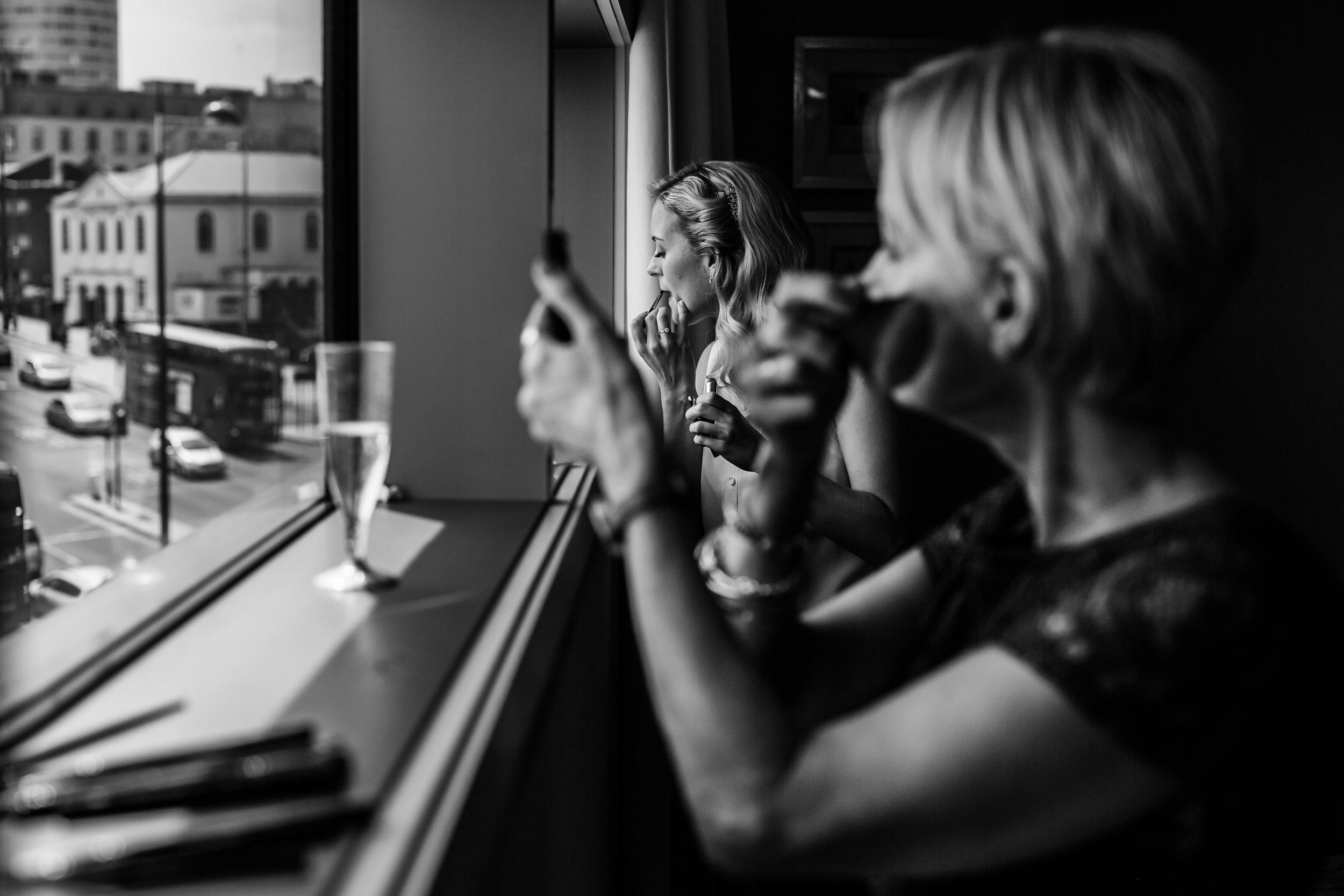 A mother and her daughter apply make up before a wedding at the Clayton Hotel Birmingham 