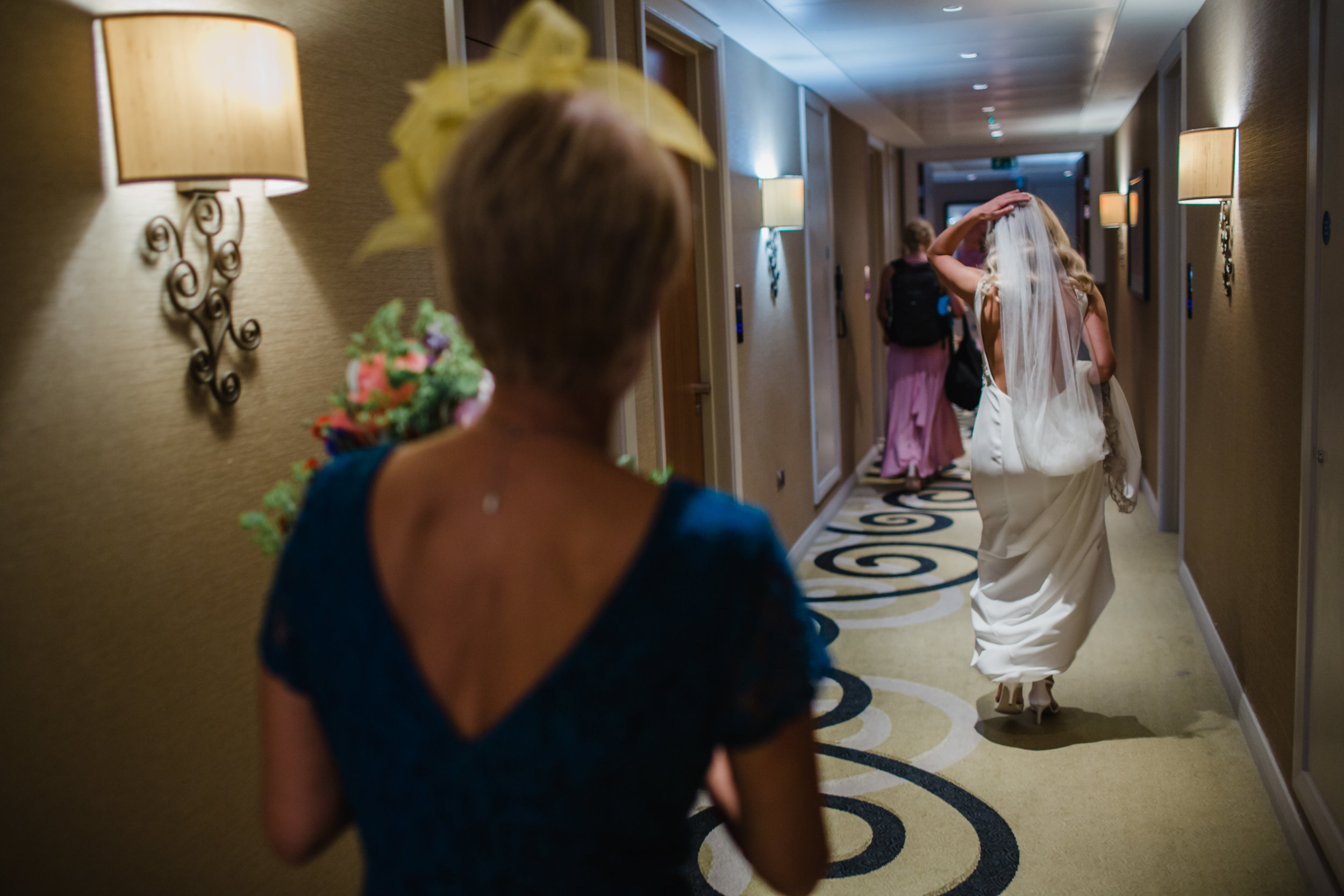 Bridal party running down the corridor of the Clayton Hotel Birmimgham
