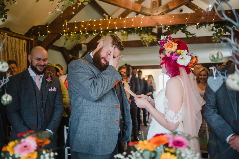 A groom cries during a wedding ceremony at the compasses at pattiswick