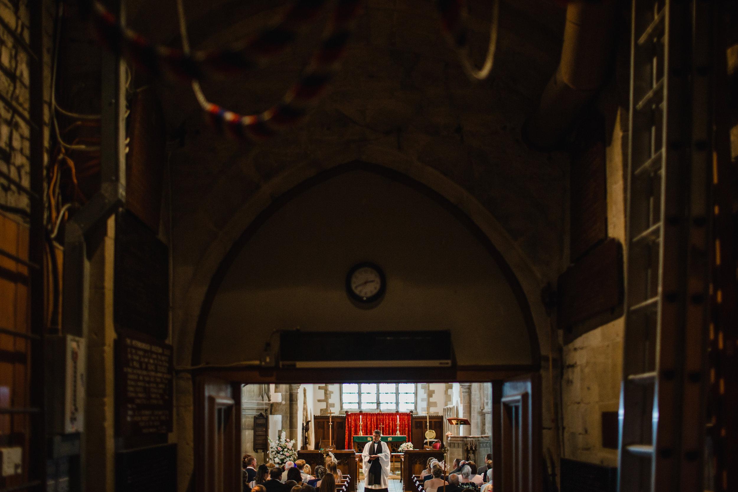 A vicar preforms a wedding ceremony 