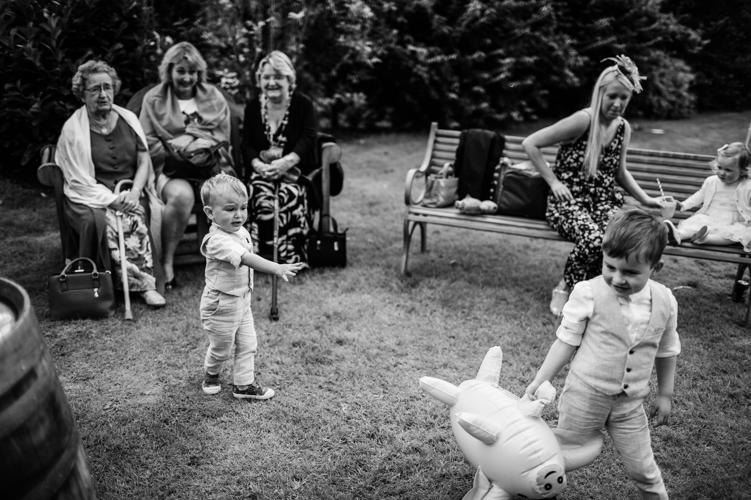 children play with inflatable pigs at a wedding
