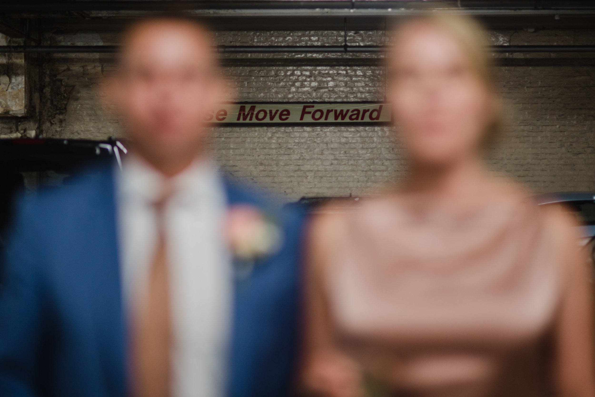 A bride and groom in the parking garage of a london hotel