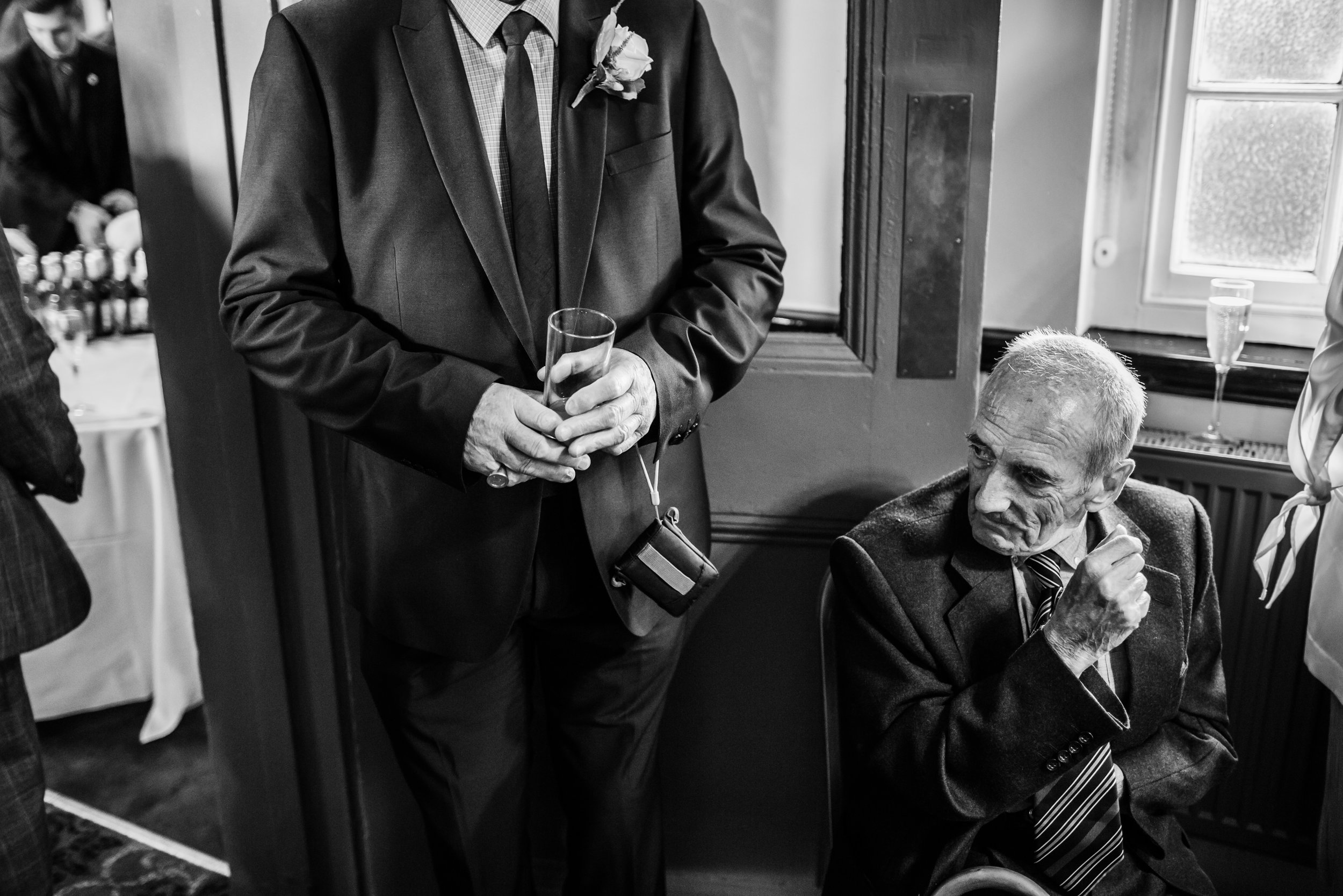 older guests at a wedding take a breather at the raven hall corby