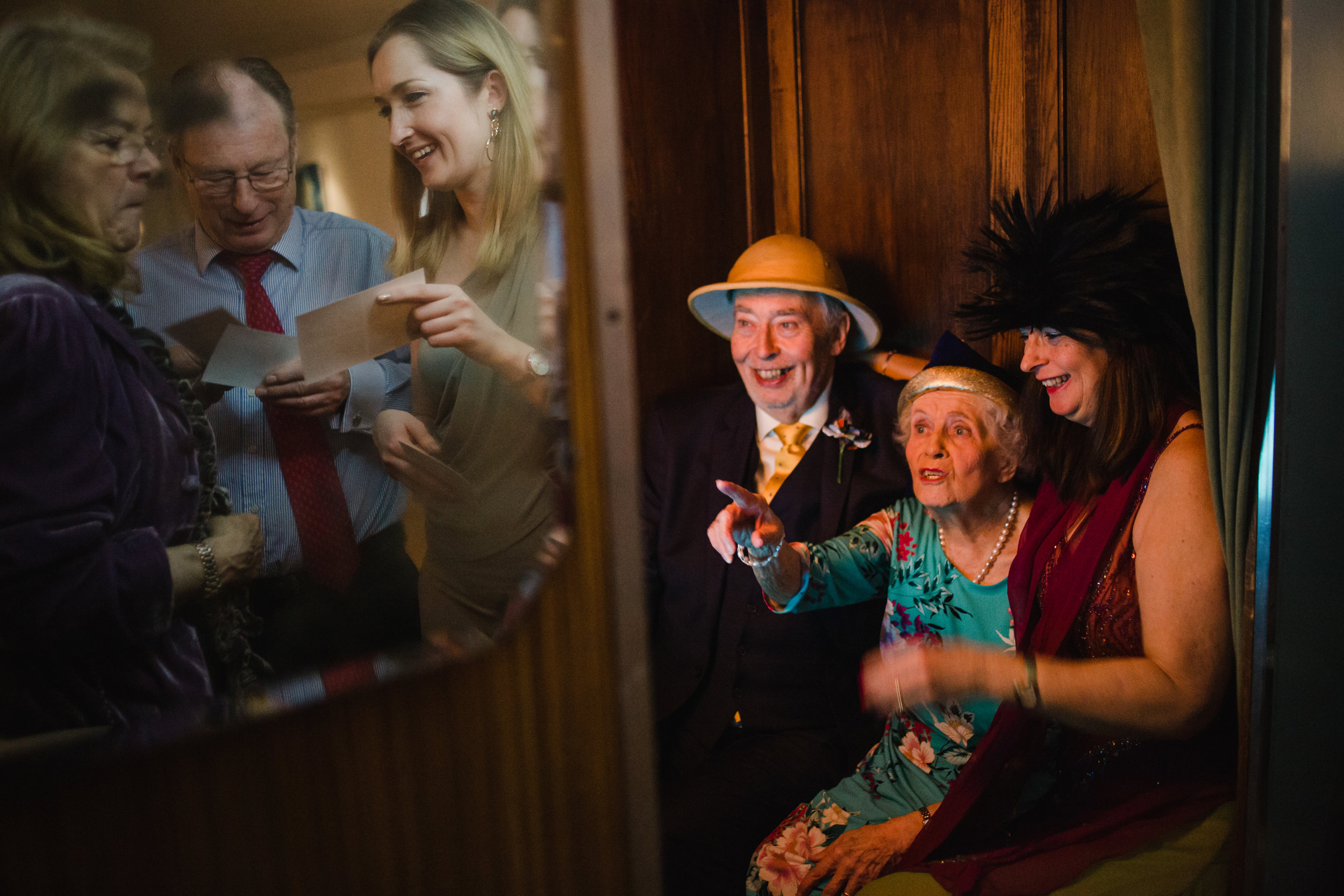 older wedding guests have a photo in a photobooth at a wedding bristol