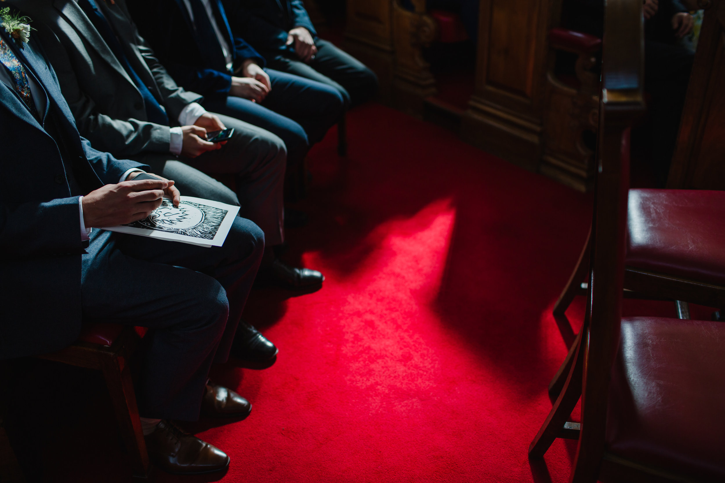 Groomsman waiting for the ceremony to start at islington town hall. 