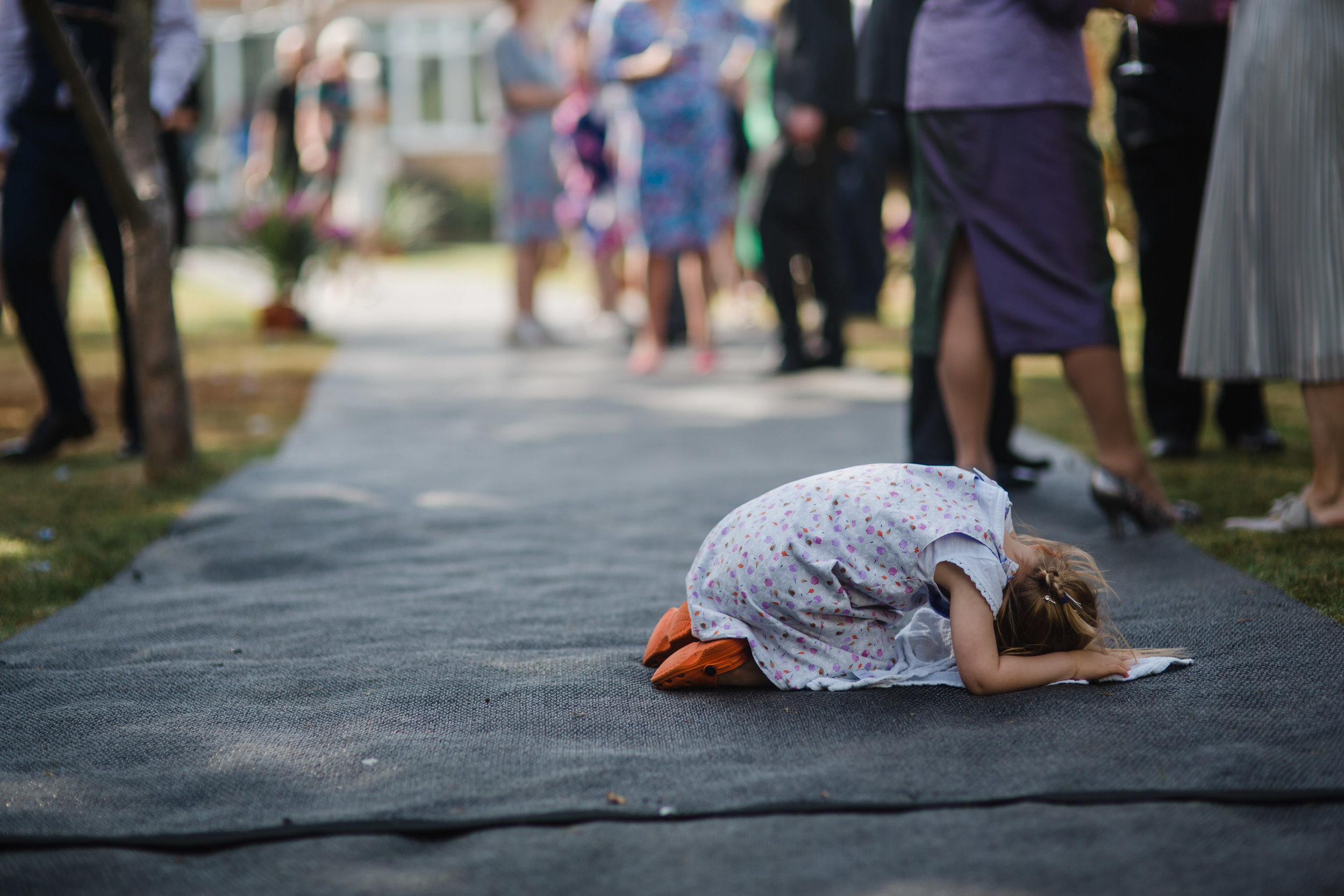 a child cries on the floor at a wedding