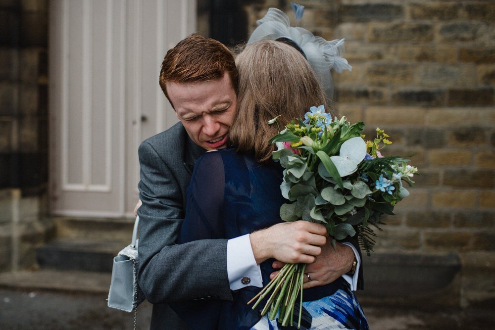 a mother and son in an emotional embrace at quarry bank 