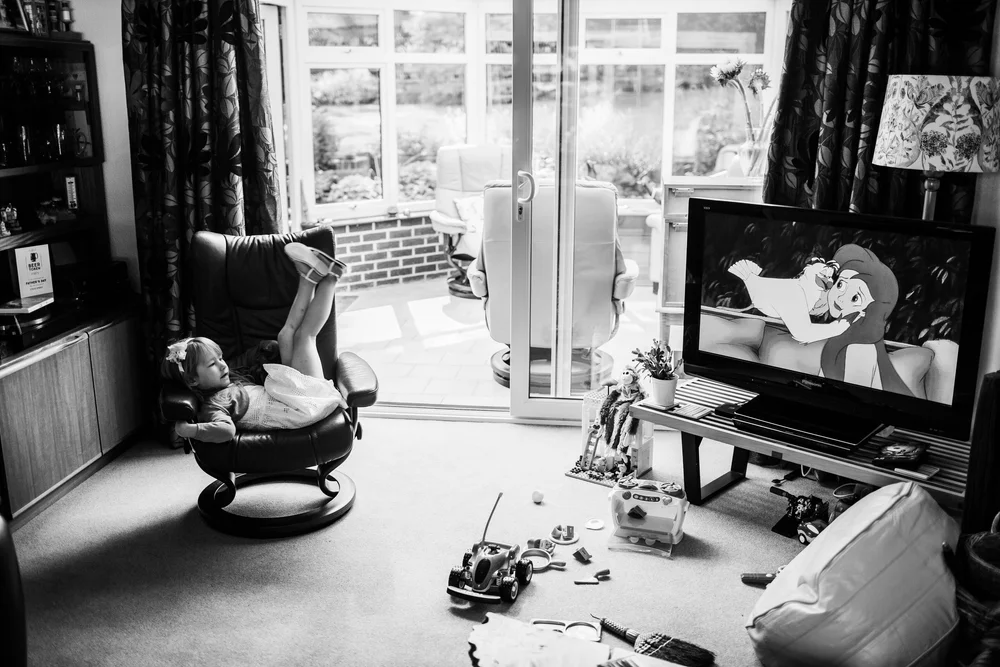 a flower girl watches Disneys little Mermaid