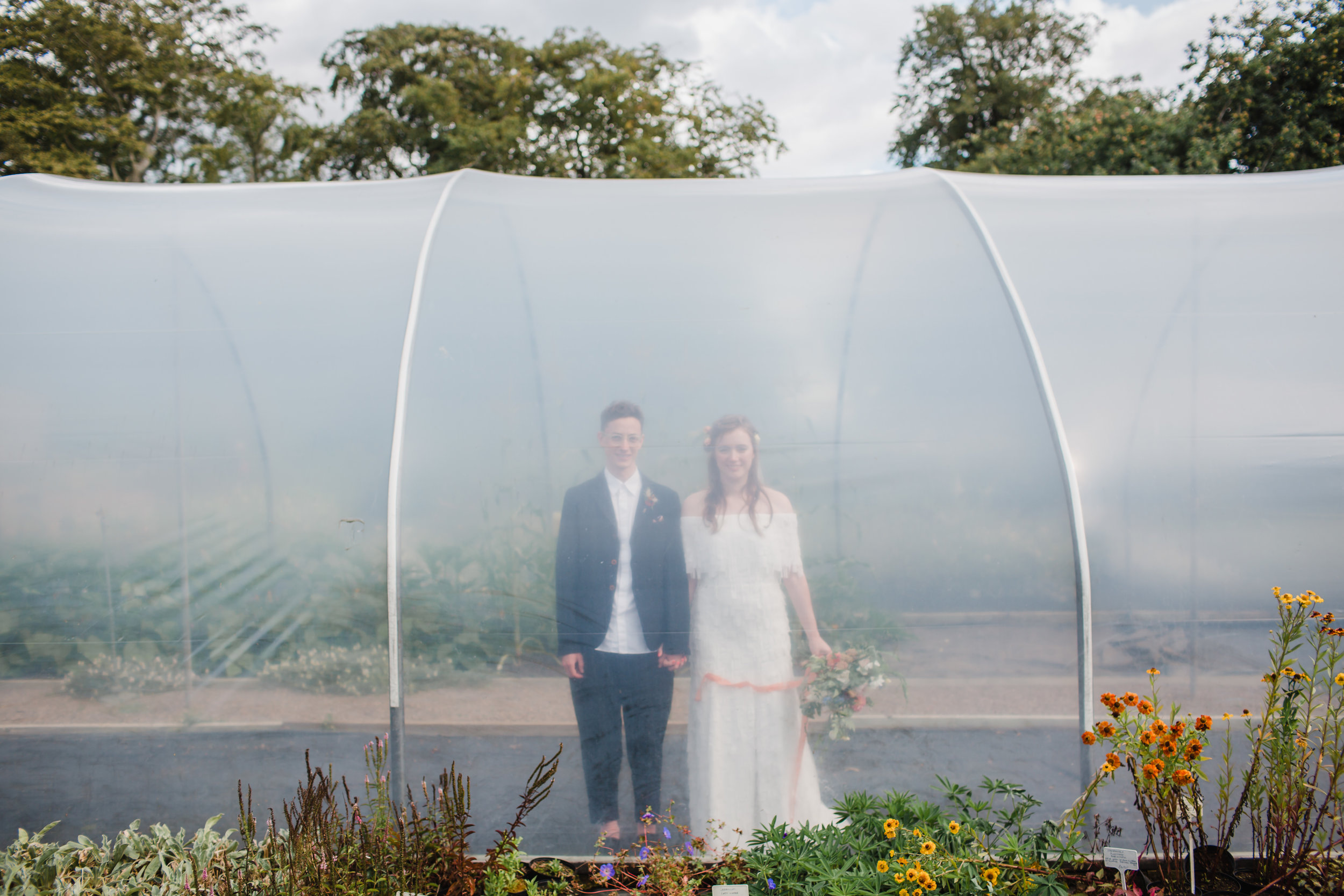 bride and groom in a poly tunnel at stanton hall and gardens