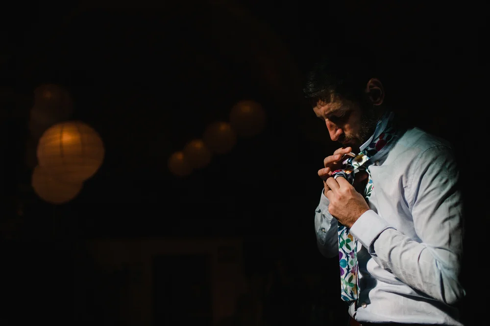 a groom gets ready for the ceremony in snowdonia