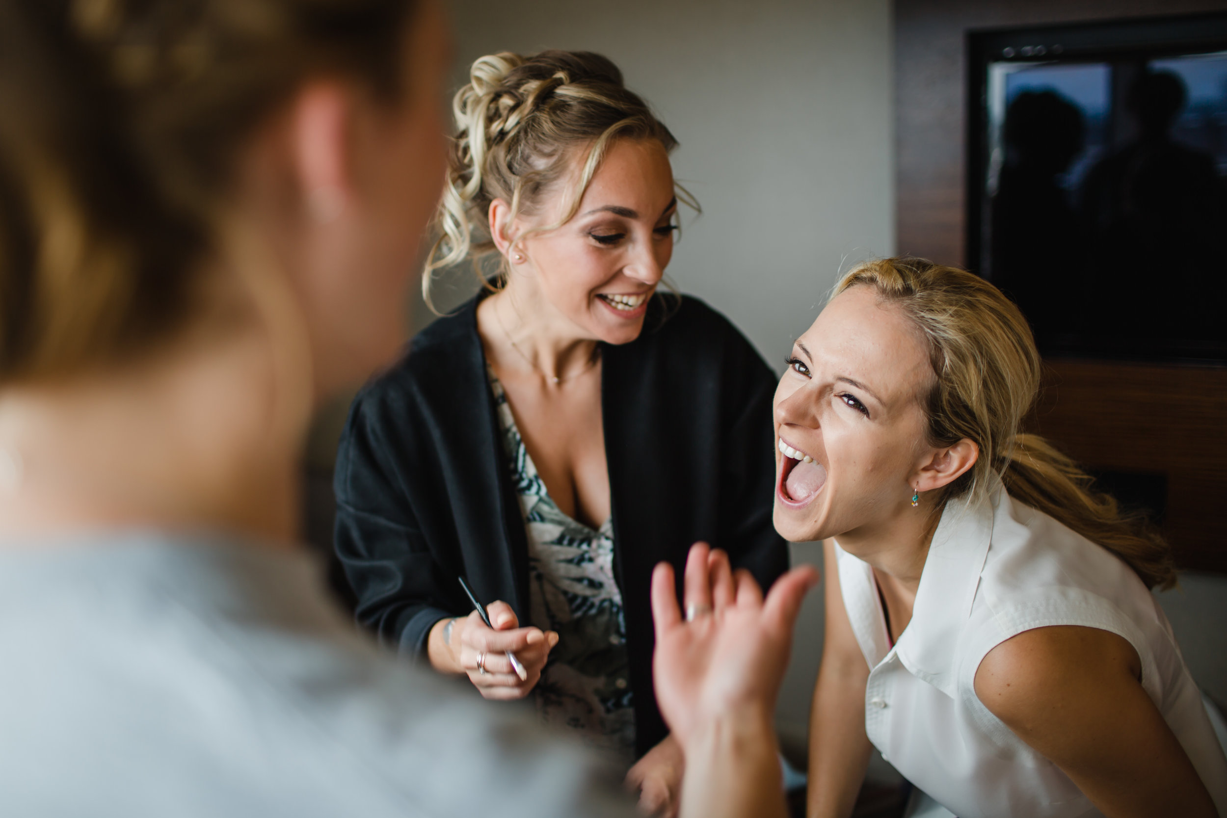  a bride laughs uncontrollably while getting ready at the clayton hotel Birmingham