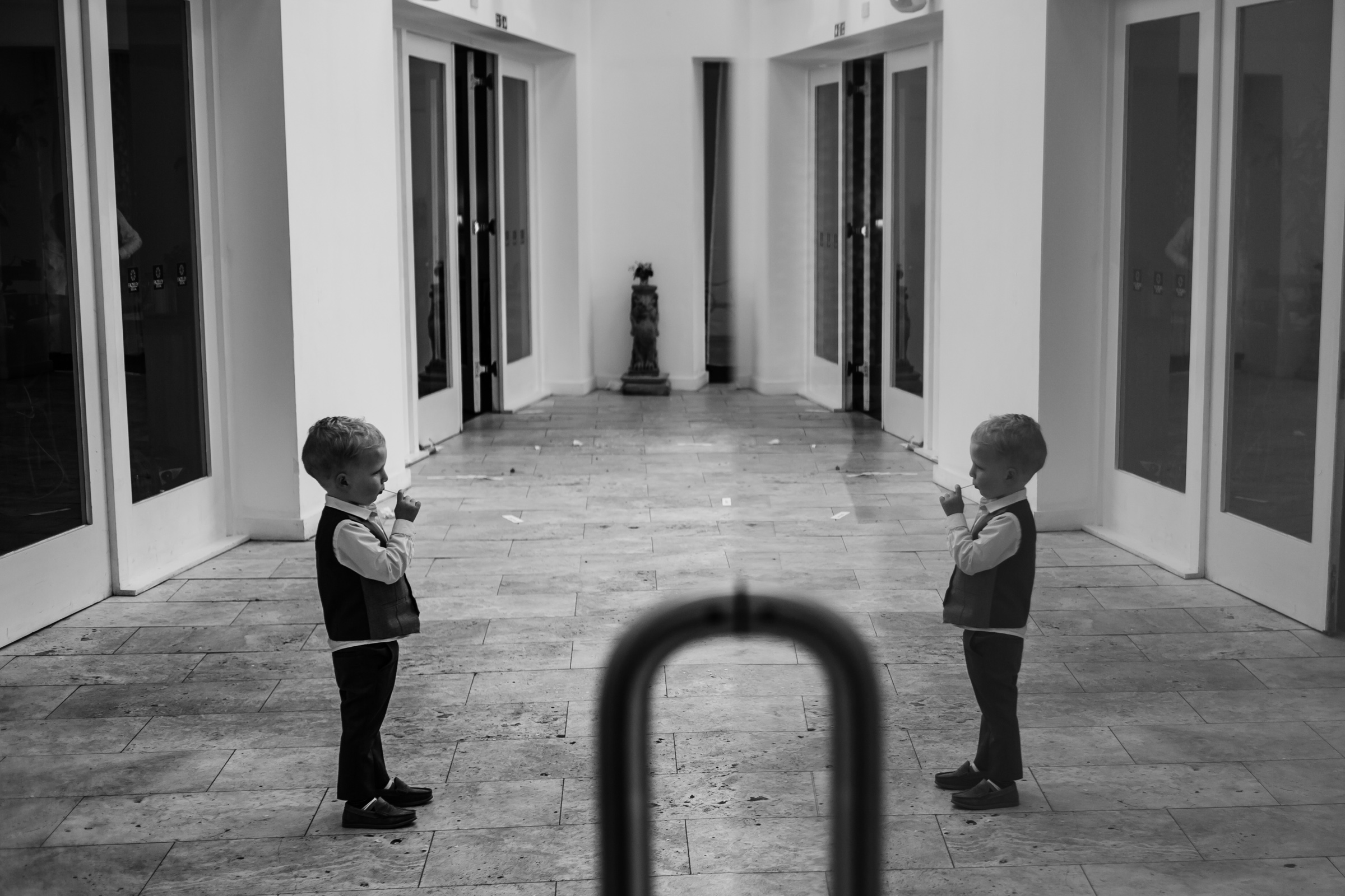 a small boy looks at his reflection at fazeley studio wedding