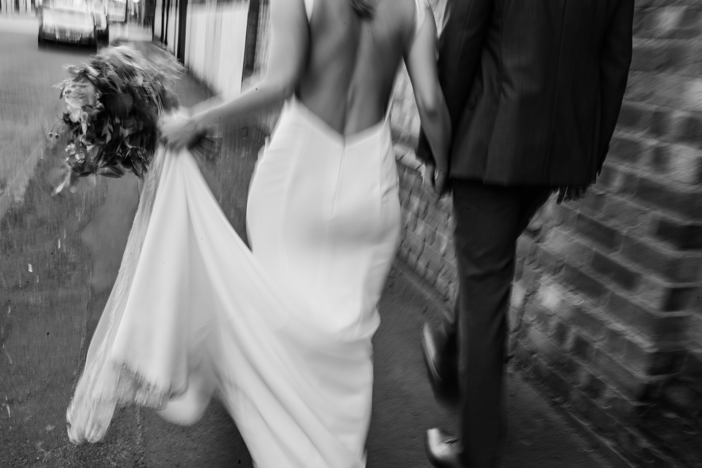 a bride and groom walk the image is out of focus in Digbeth Birmingham 