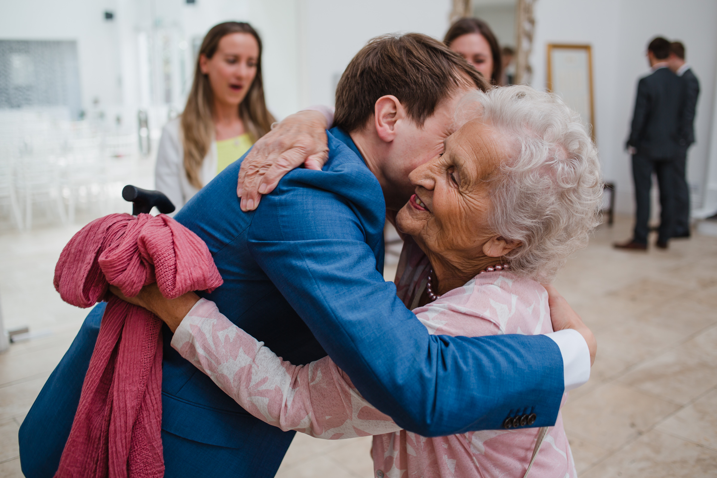 grandma gets a hug from the groom at a wedding at fazeley studios.