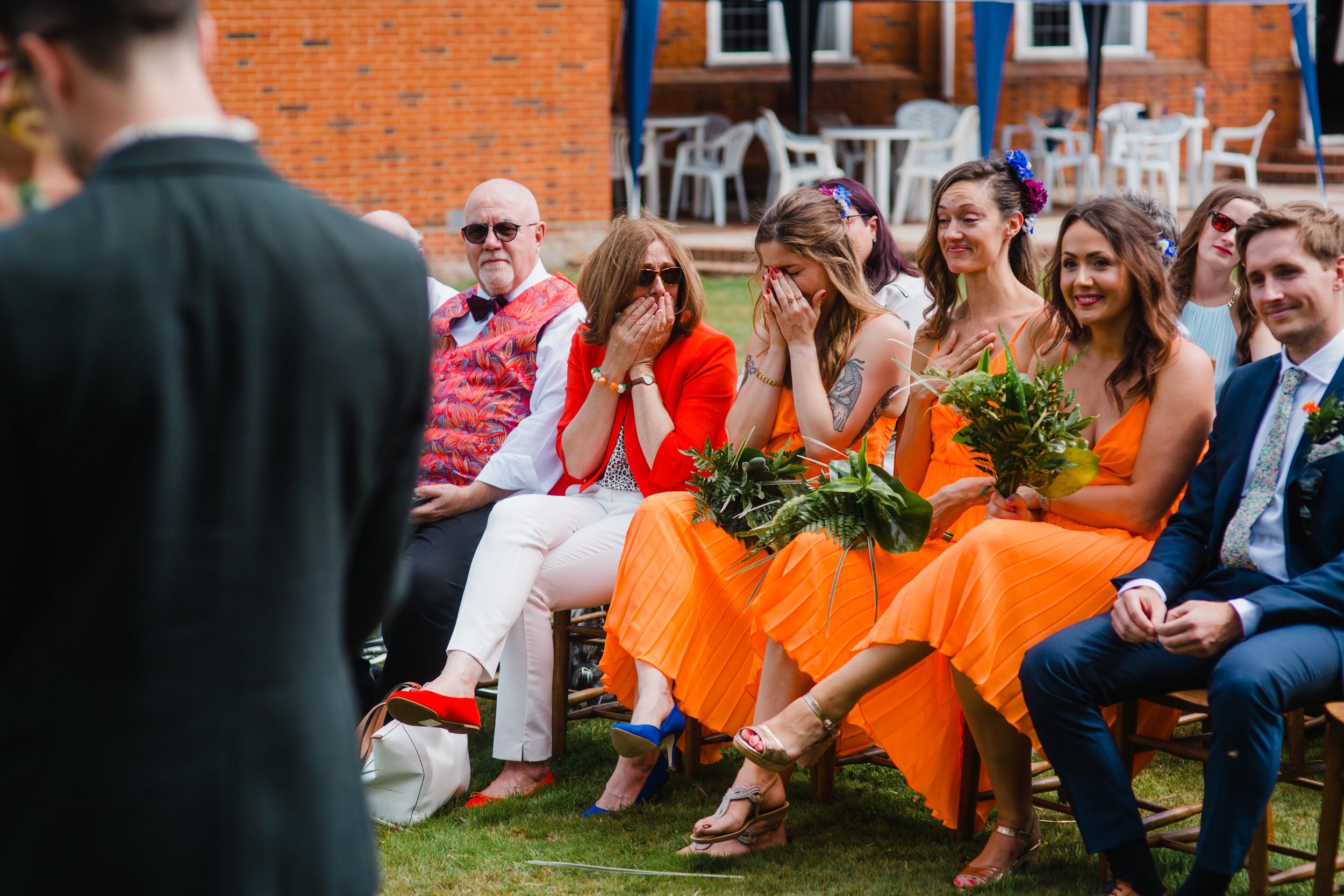 bridesmaids and family get emotional during a wedding ceremony