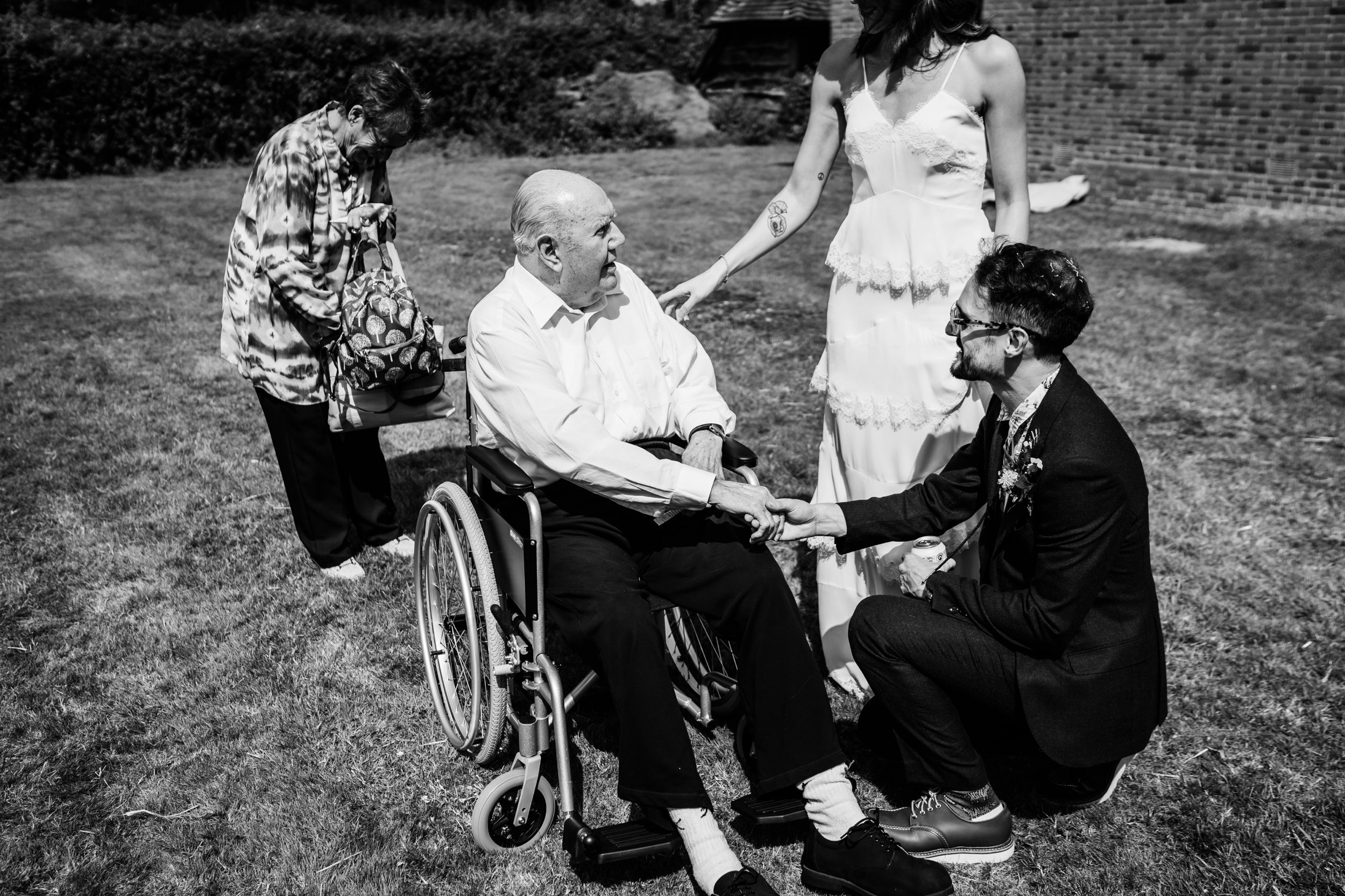 a touching moment between a grandfather and a bride and groom 