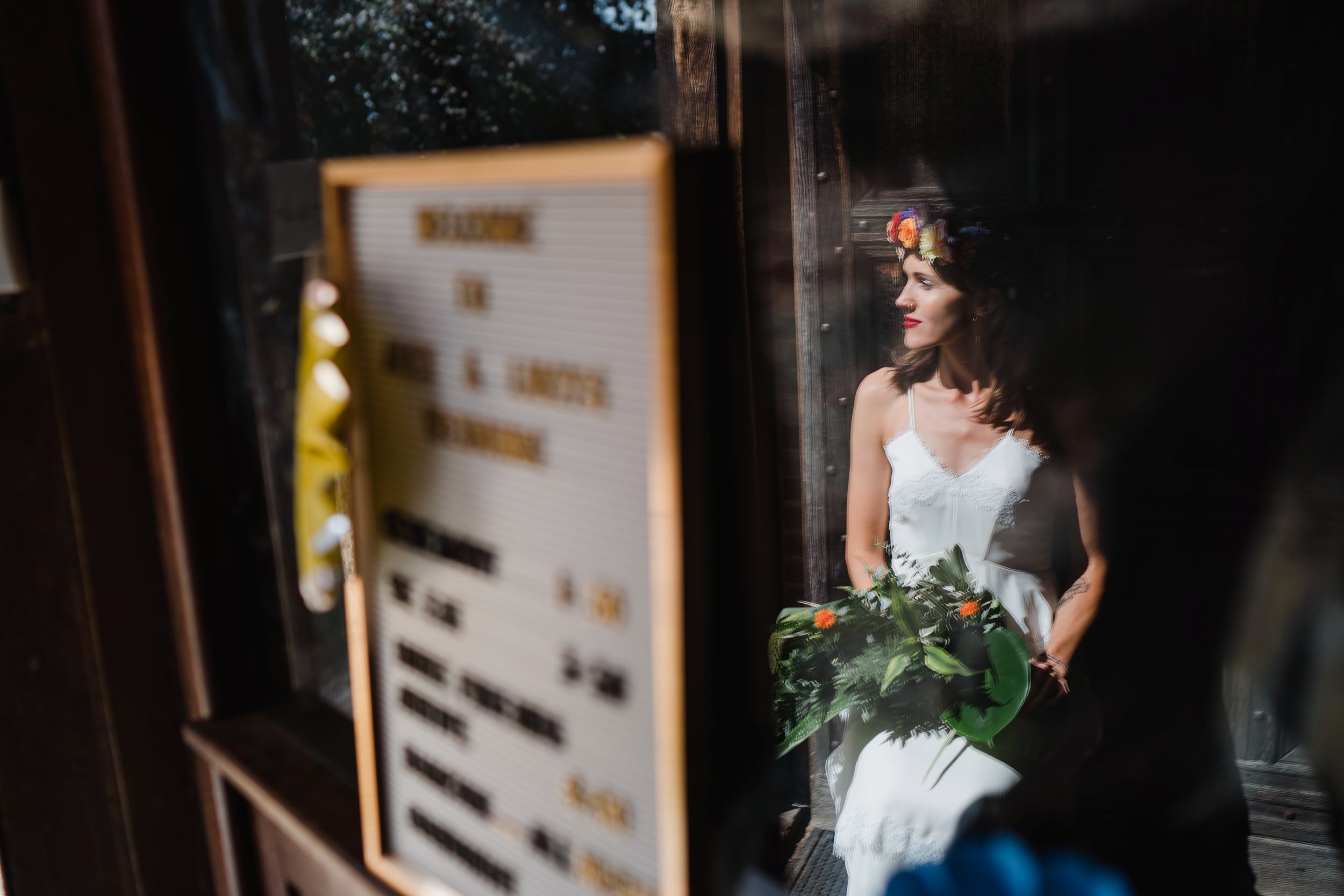 a portrait of a bride reflected in glass