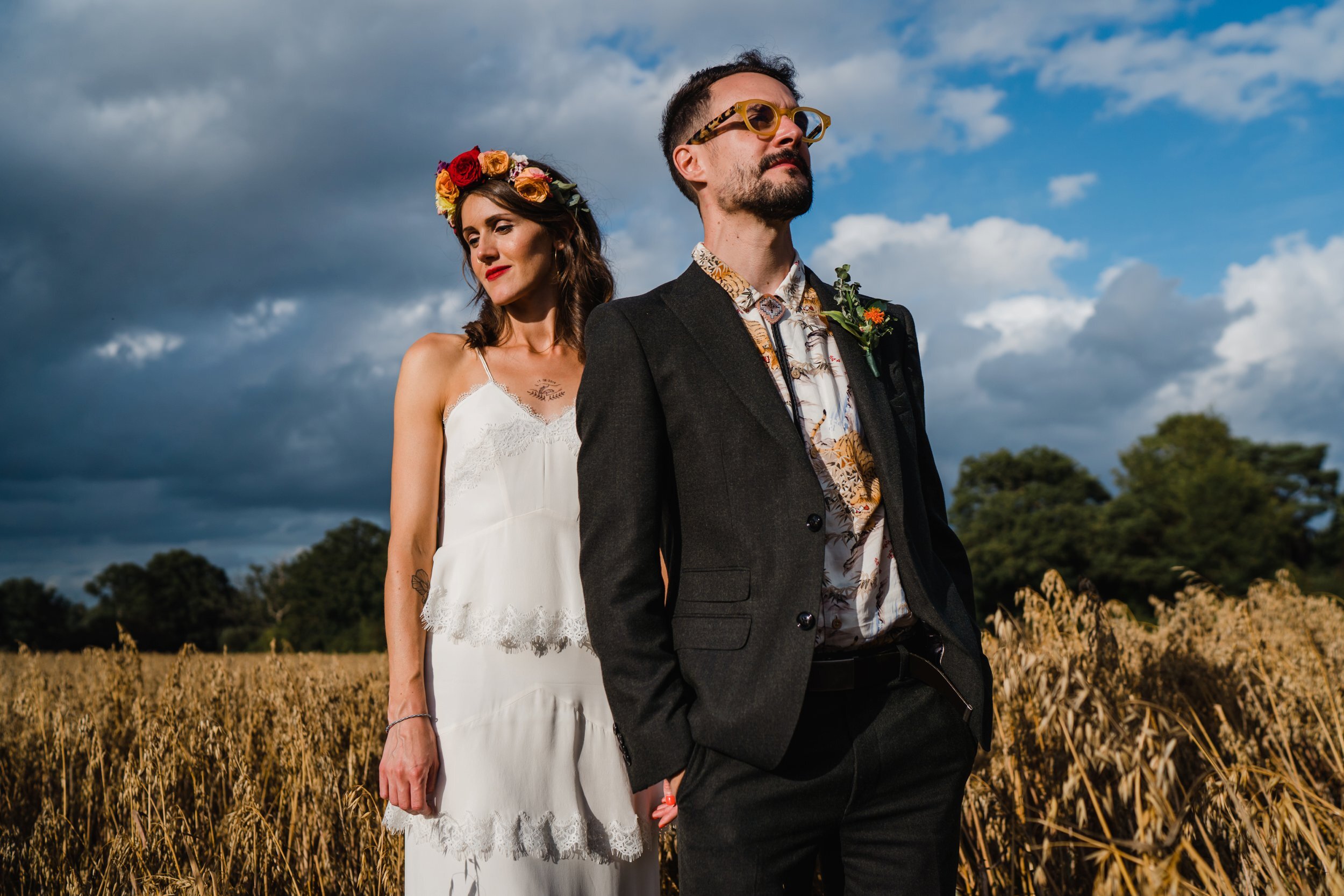 a contemporary wedding portrait in a field 