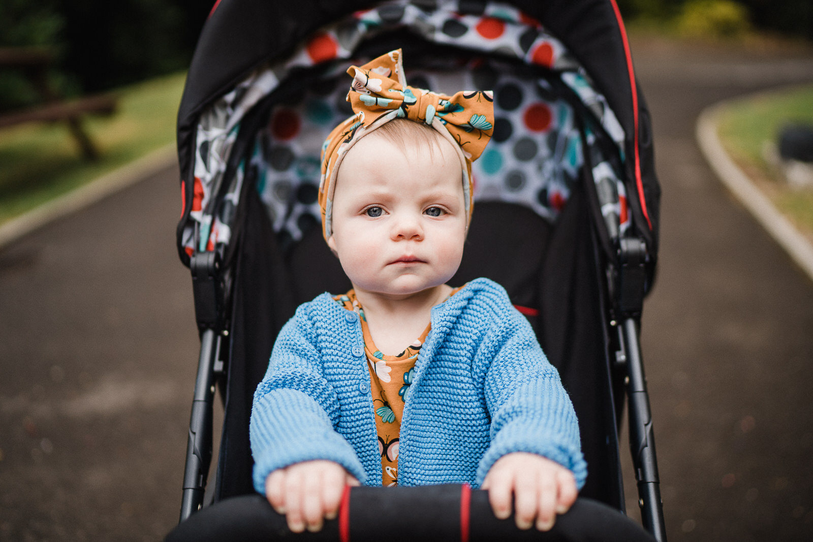 moody child in a pushchair at highbury hall