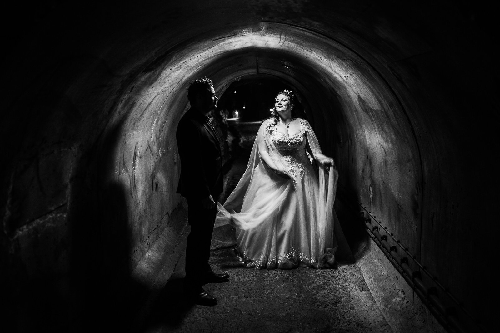 bride and groom in a cheese tunnel at cheddar gorge